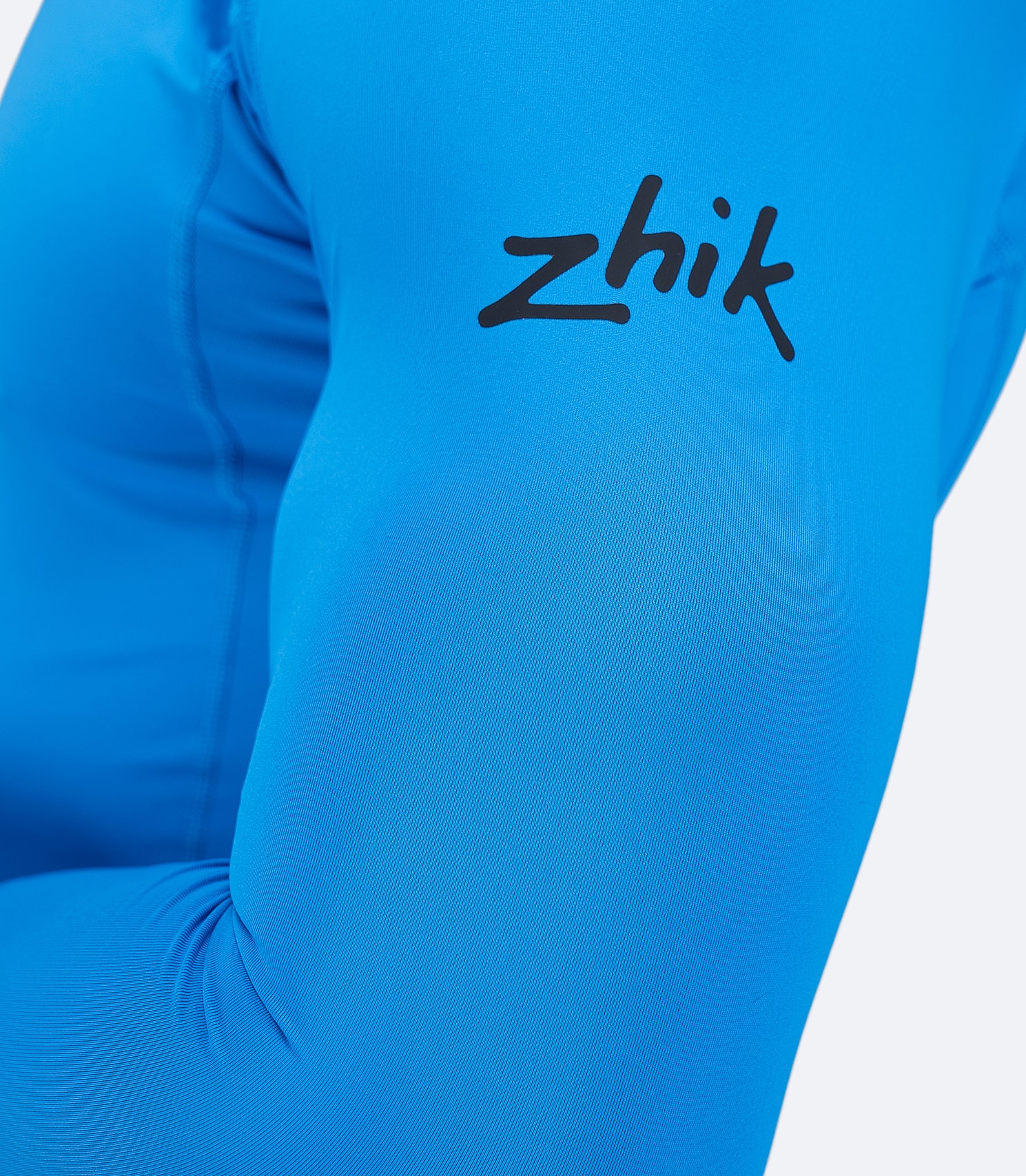 Zhik logo on sleeve of Cyan Eco Spandex LT Top, showing anti-rash flatlock stitching and soft recycled spandex.