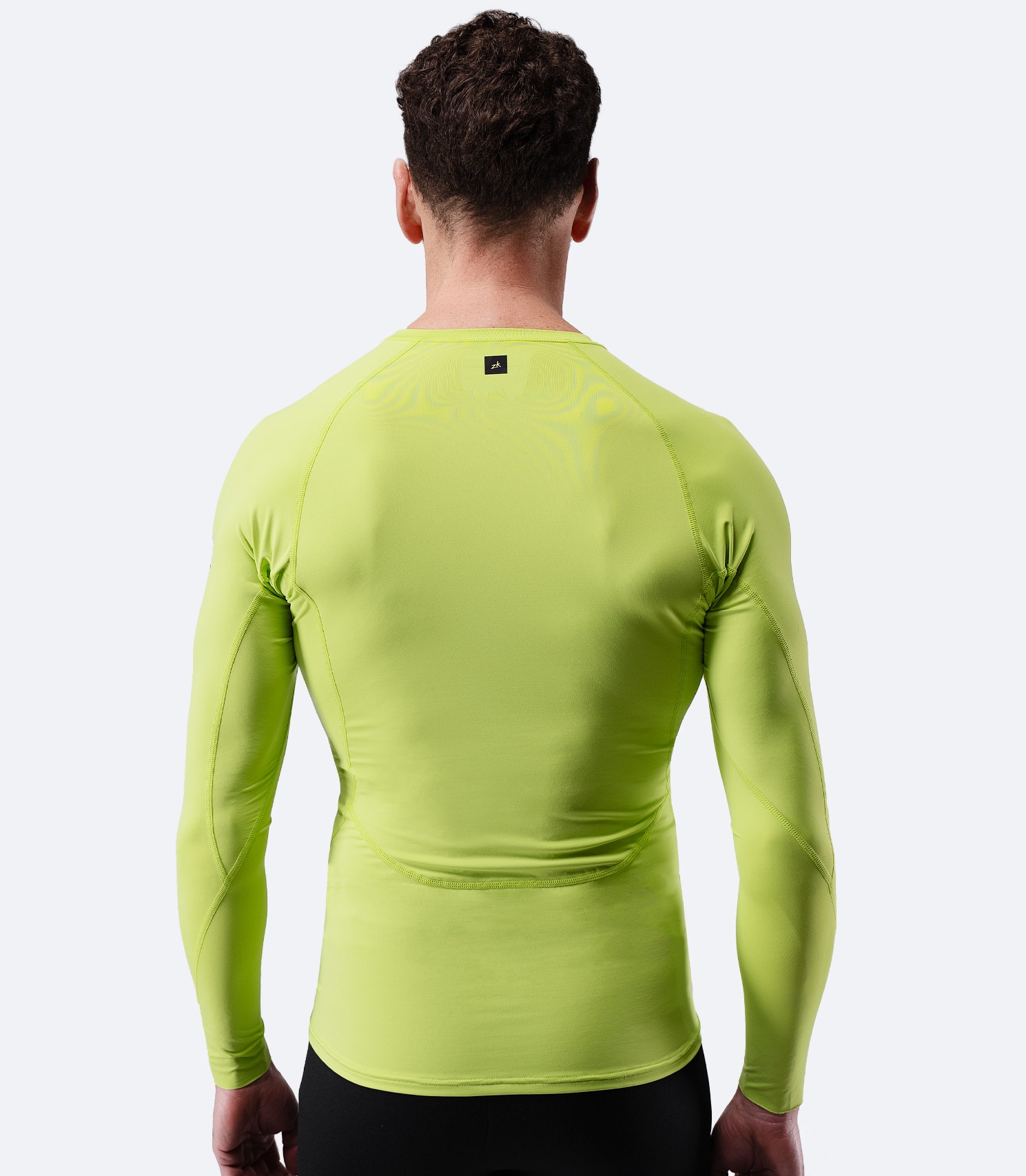 Back view of Zhik Men’s Eco Spandex LT Long Sleeve Baselayer Top in lime