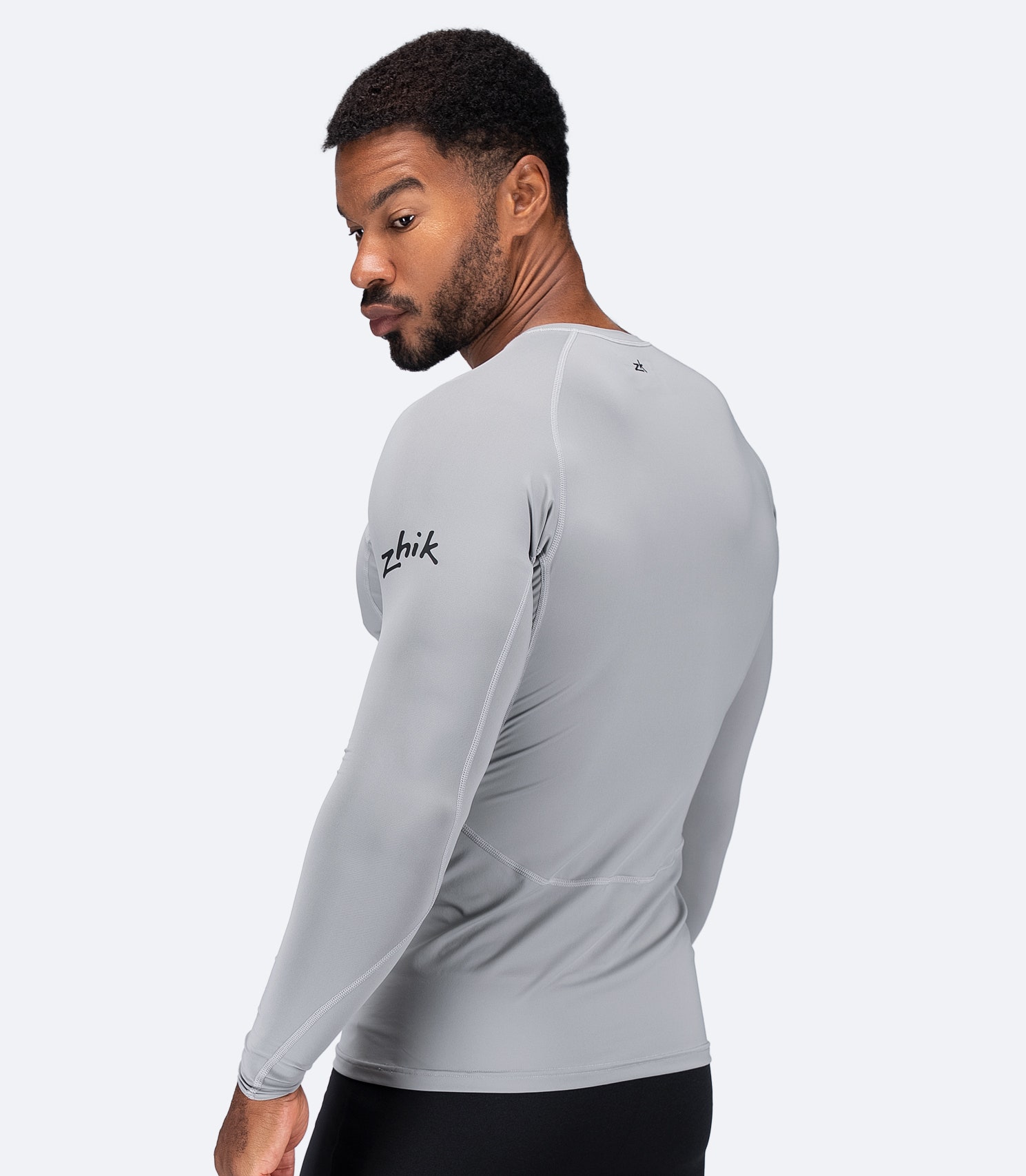 Side view of Zhik Men's Eco Spandex LT Top in Platinum, showing contoured fit and ultra-lightweight fabric for paddle sports.