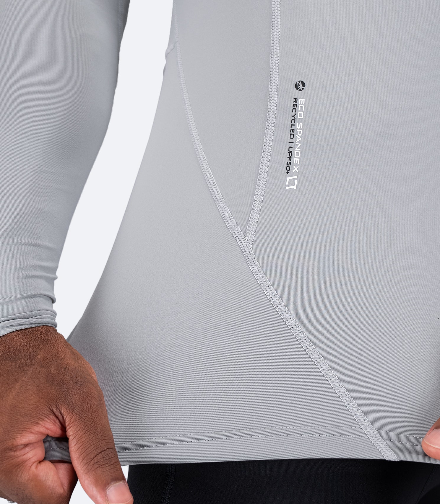 Zhik logo near waist on Platinum Eco Spandex LT Top, highlighting flexible, soft-touch recycled nylon blend fabric.