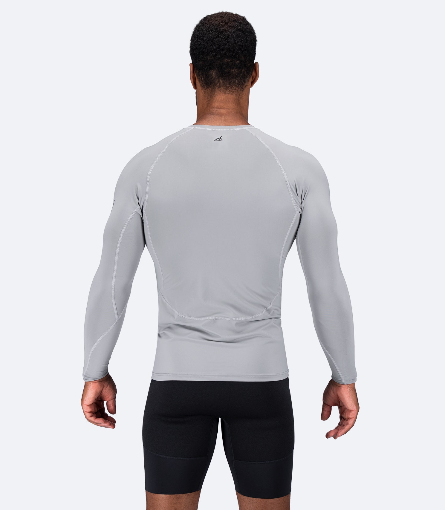 Back view of Zhik Men's Eco Spandex LT Top in Platinum, showcasing breathable fabric and flatlock seams for all-day comfort.