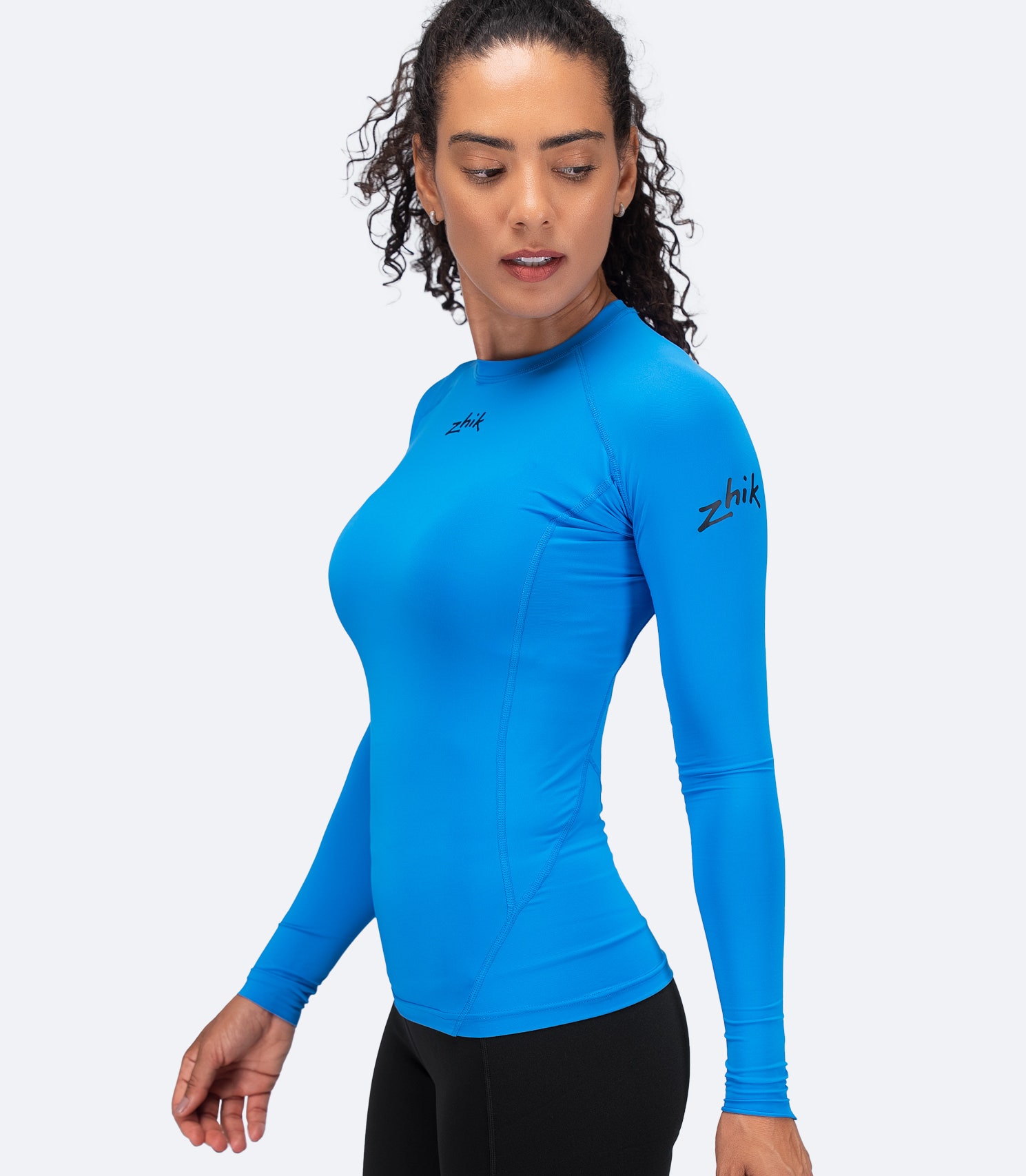 Zhik Women's Cyan Eco Spandex LT Top side view showing lightweight, 4-way stretch fit for paddle performance.