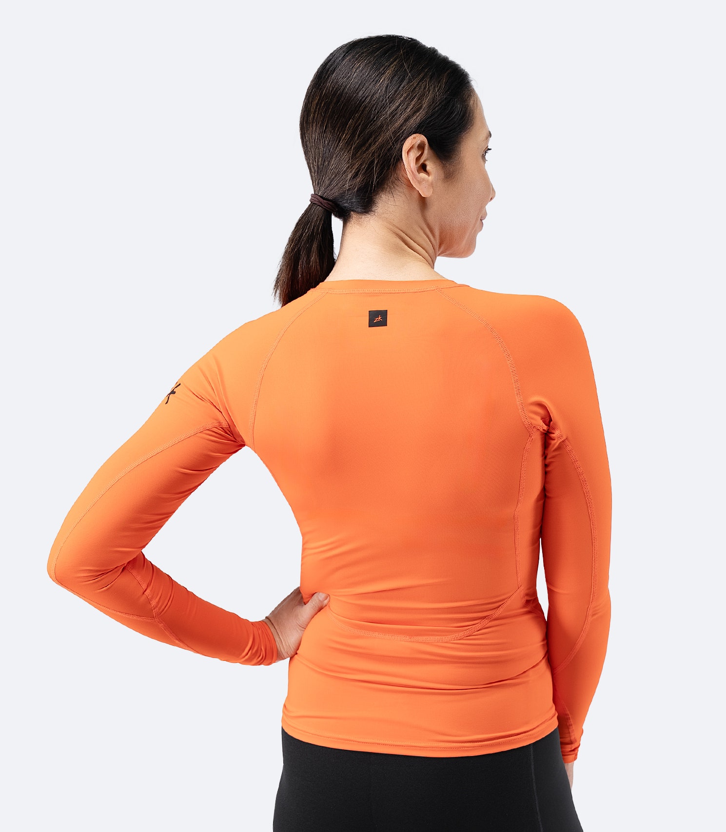 Back view of Zhik Women’s Eco Spandex LT Long Sleeve Baselayer Top in flame red