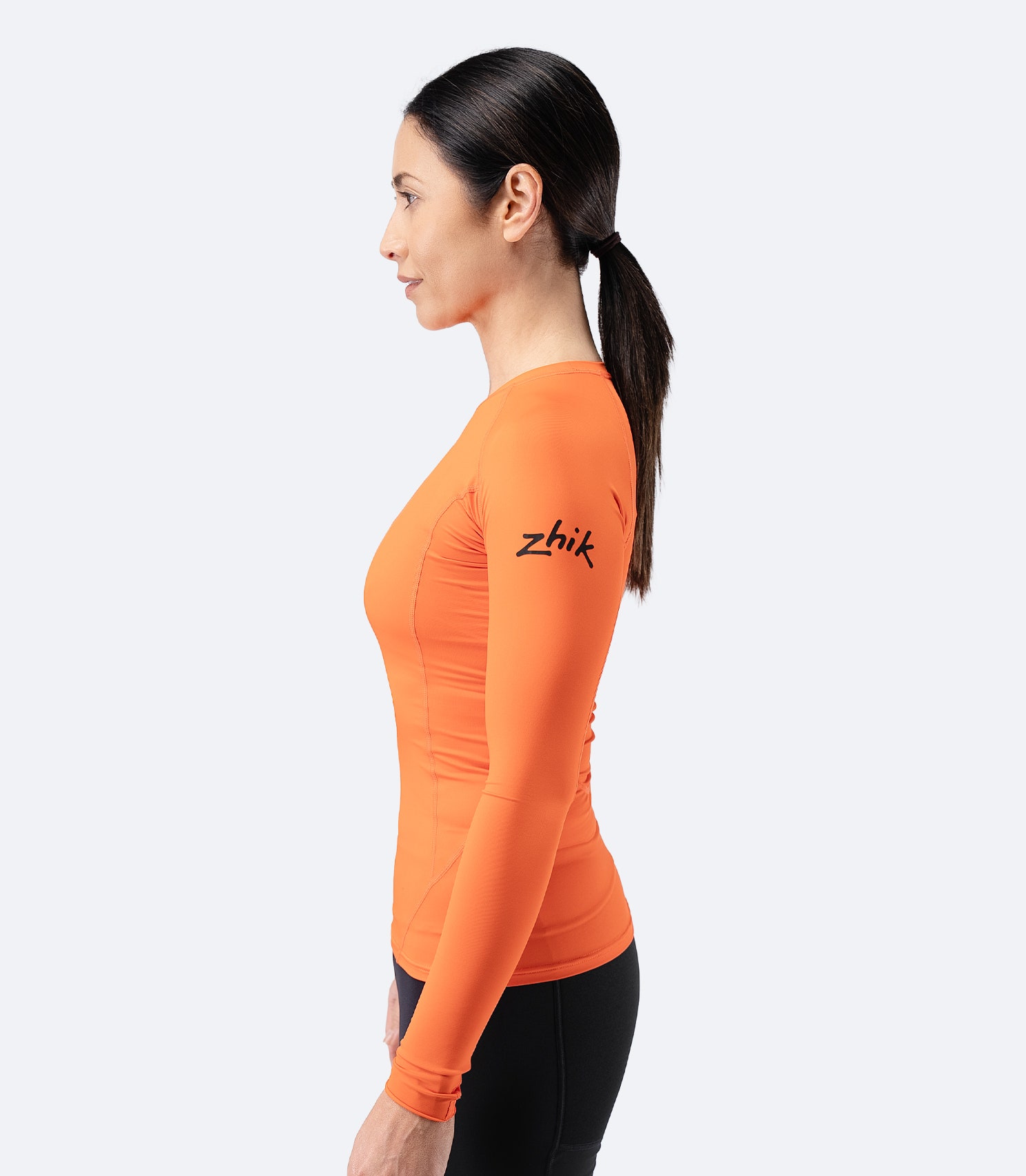 Side profile of Zhik Women’s Eco Spandex LT Long Sleeve Baselayer Top in flame red