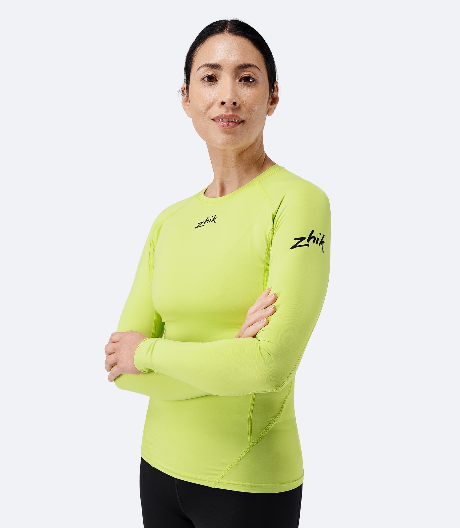 Model front-facing in Zhik Women’s Eco Spandex LT Long Sleeve Baselayer Top in lime