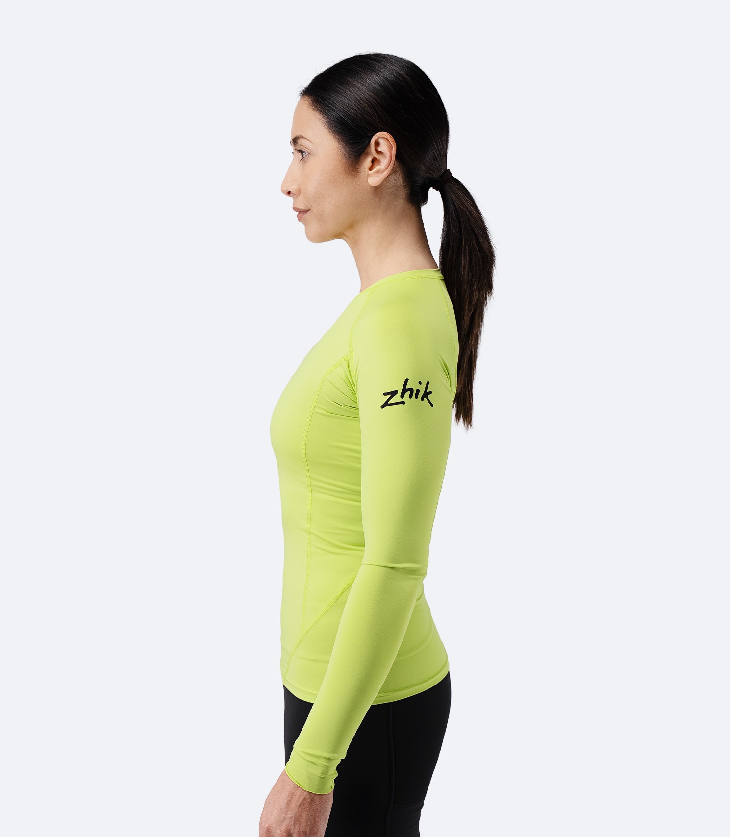 Side profile of Zhik Women’s Eco Spandex LT Long Sleeve Baselayer Top in lime