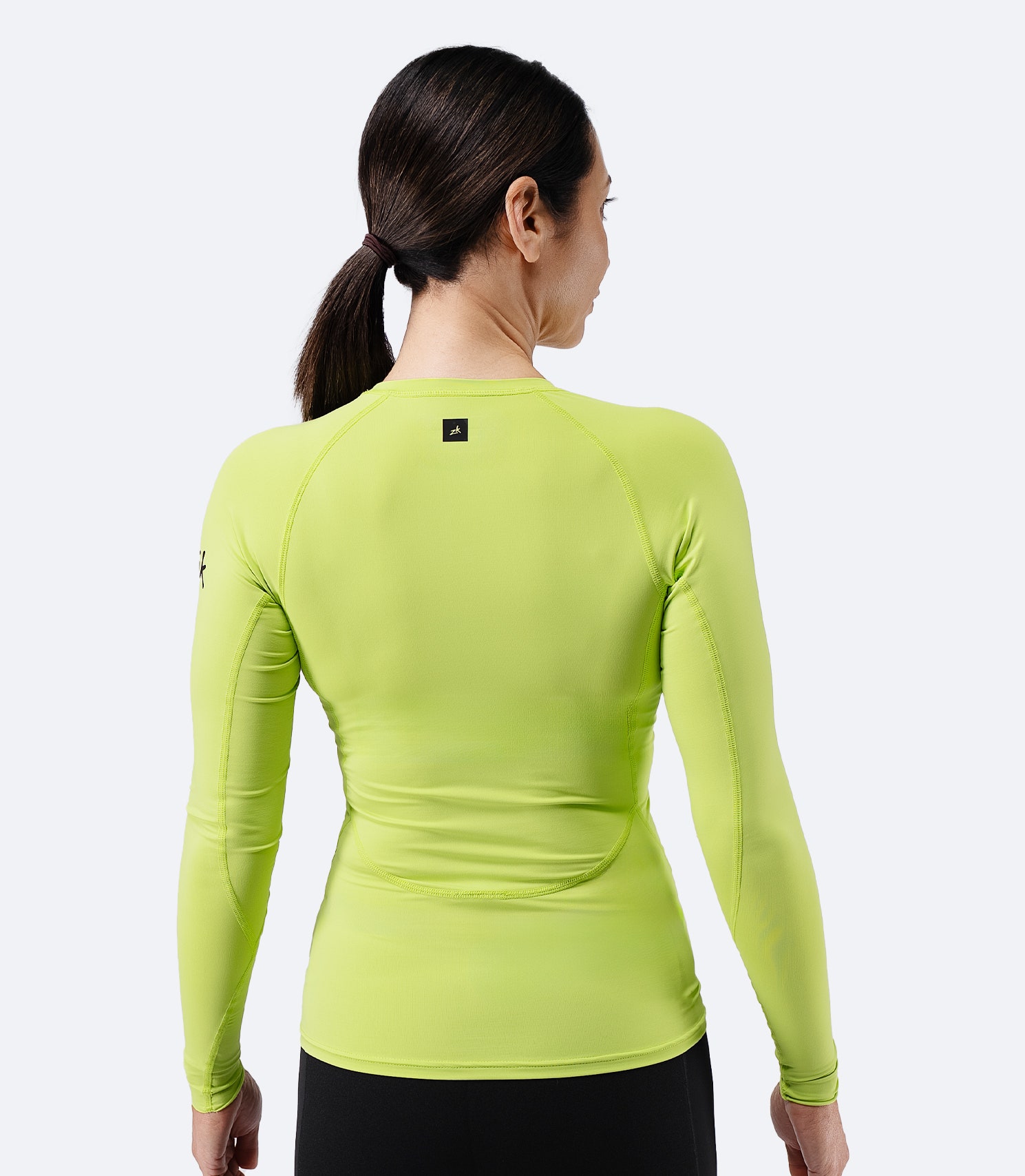 Back view of Zhik Women’s Eco Spandex LT Long Sleeve Baselayer Top in lime
