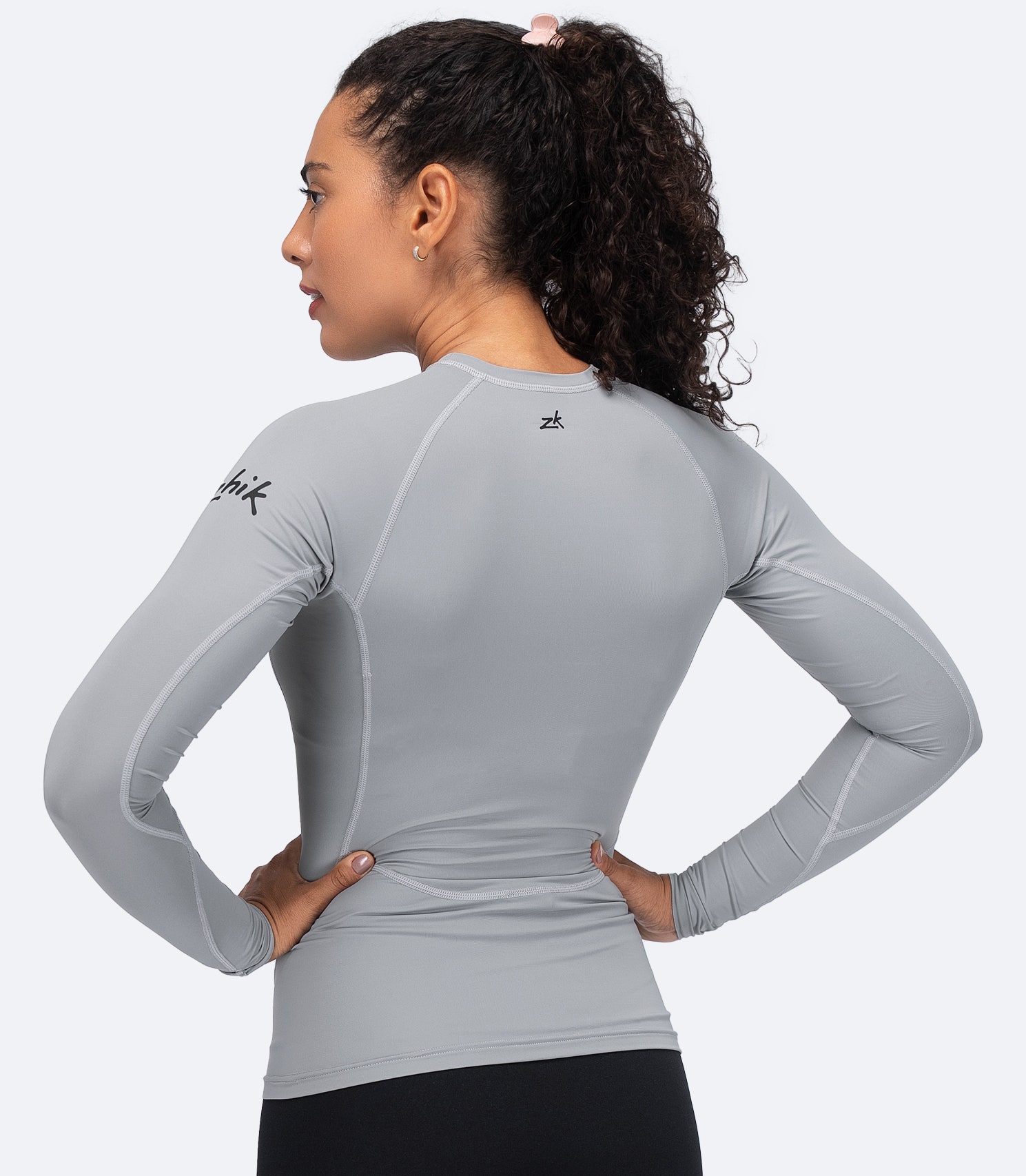 Back view of Zhik Women's Eco Spandex LT Top in Platinum with athletic fit and moisture-wicking stretch fabric.