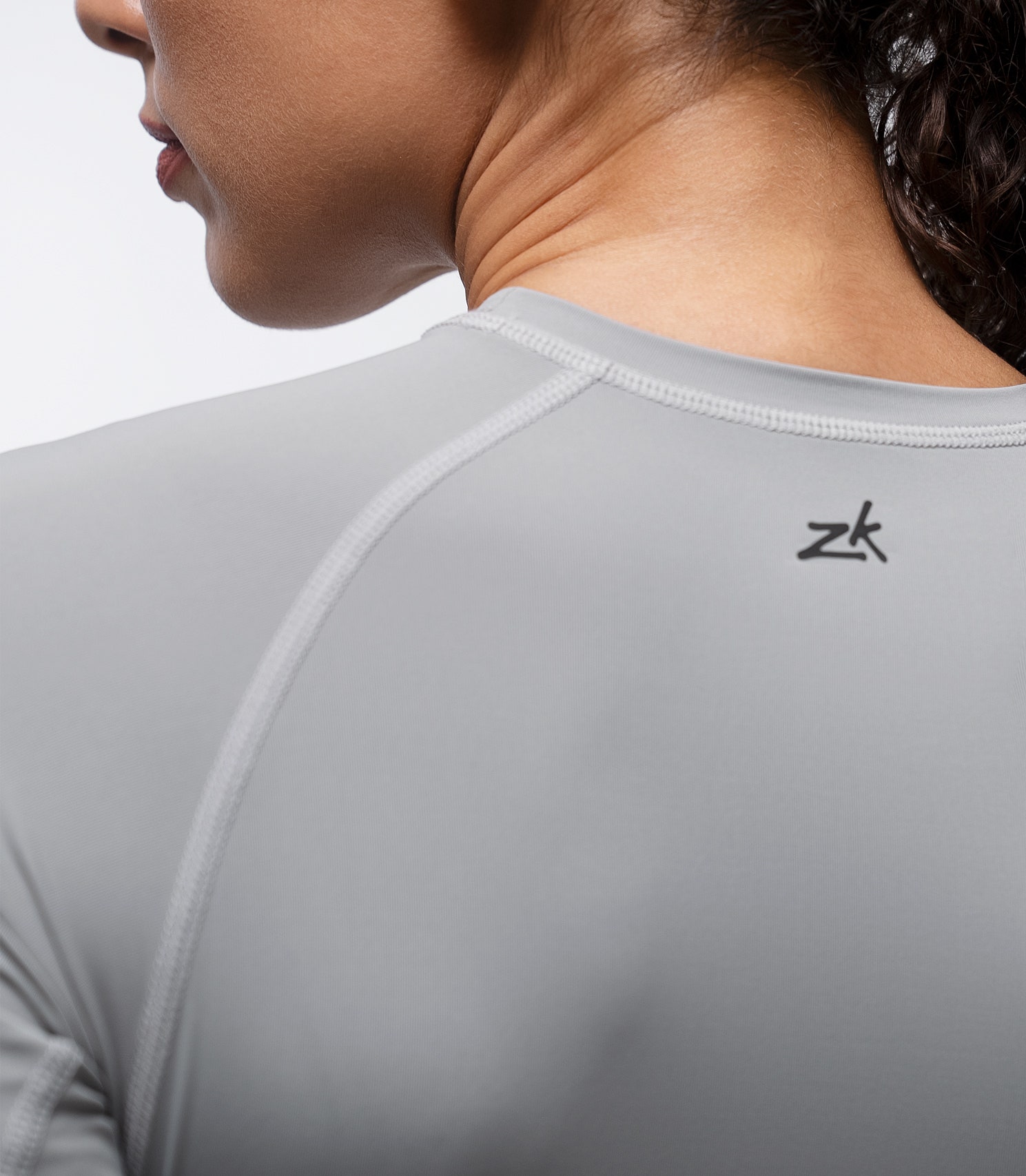 Rear shoulder close-up of Zhik Eco Spandex LT Top in Platinum with subtle Zhik logo and breathable panels.