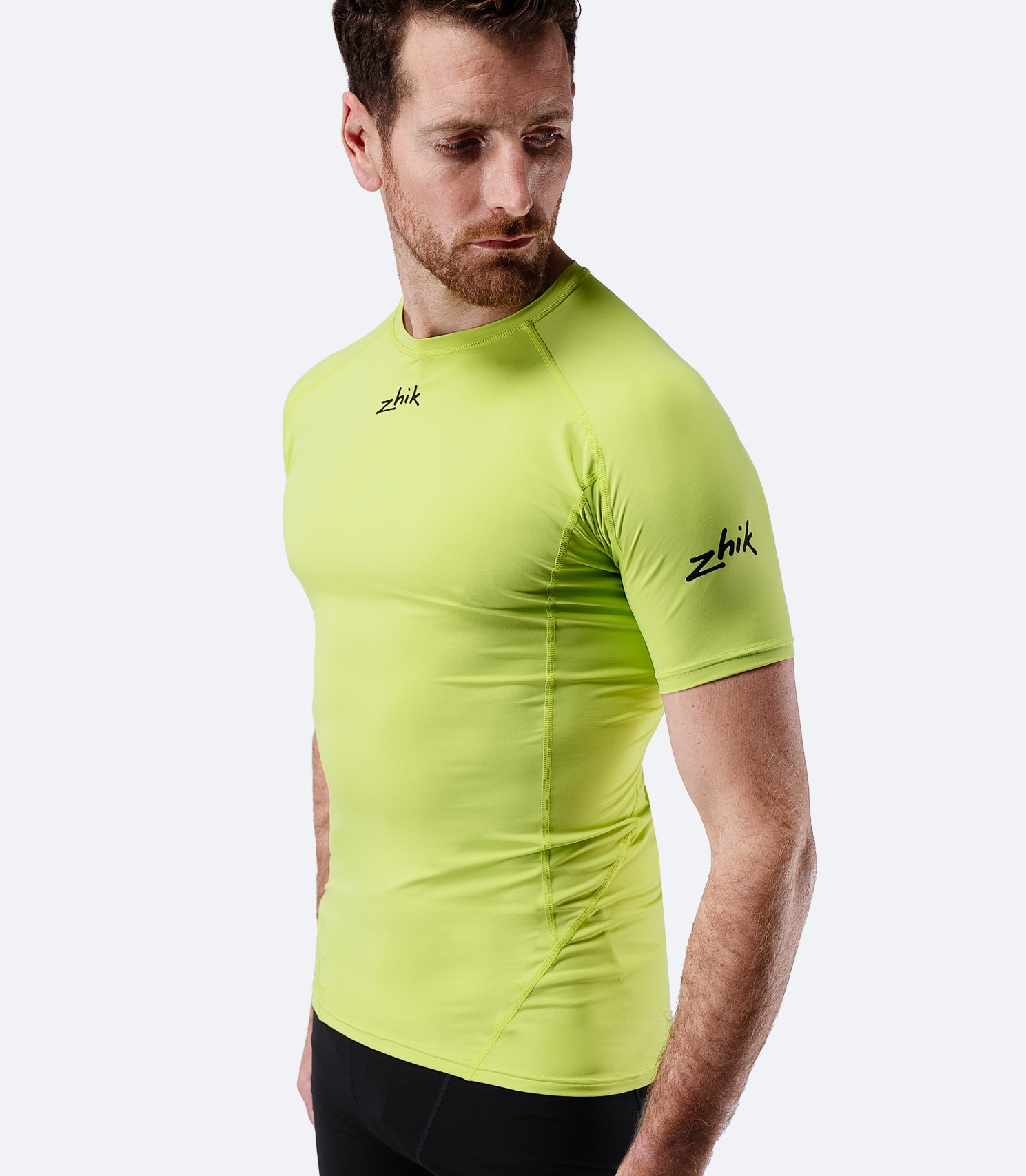 Angled front view of Zhik Men’s Eco Spandex LT Short Sleeve Baselayer Top in lime