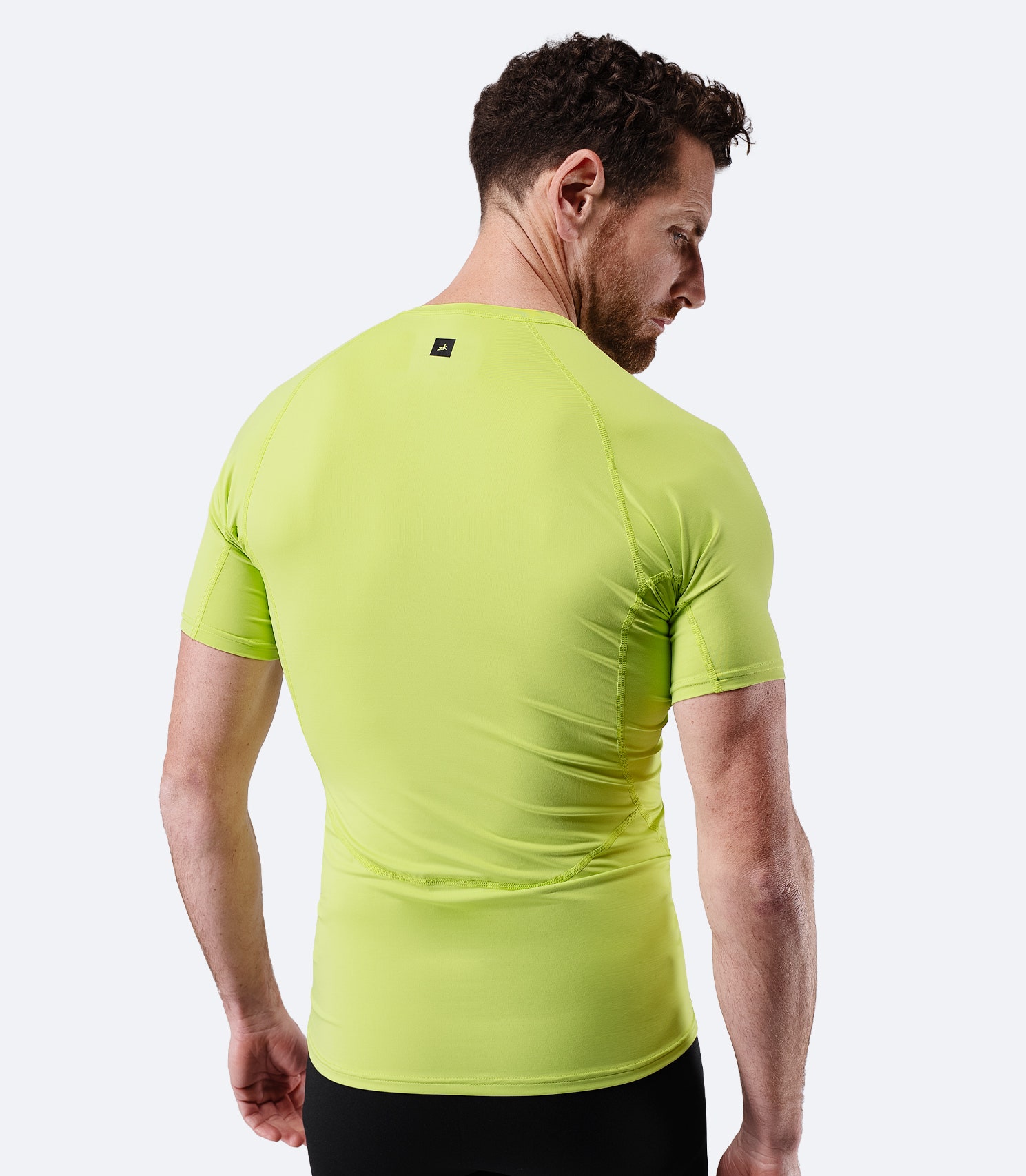 Back view of Zhik Men’s Eco Spandex LT Short Sleeve Baselayer Top in lime