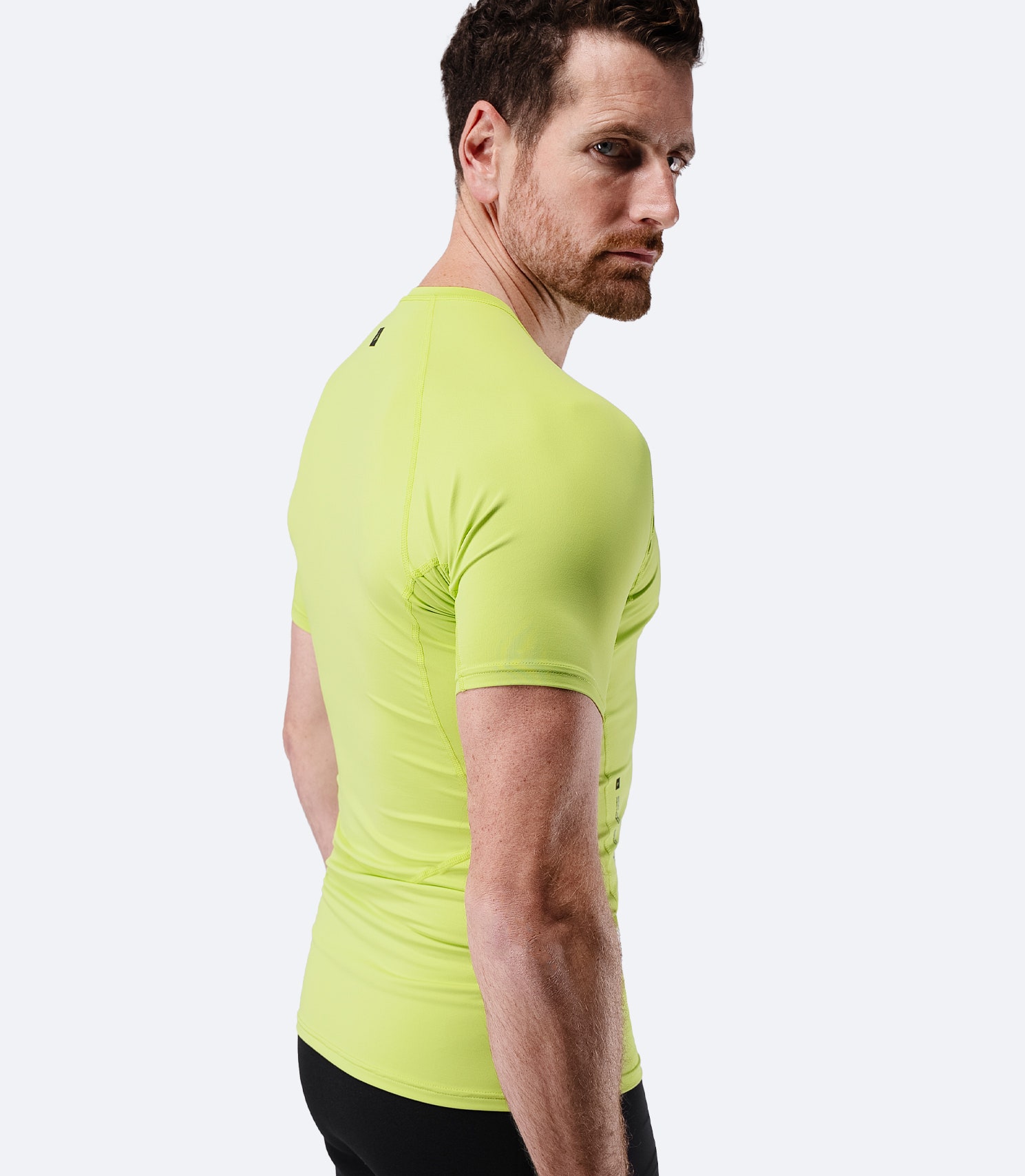 Side profile of Zhik Men’s Eco Spandex LT Short Sleeve Baselayer Top in lime