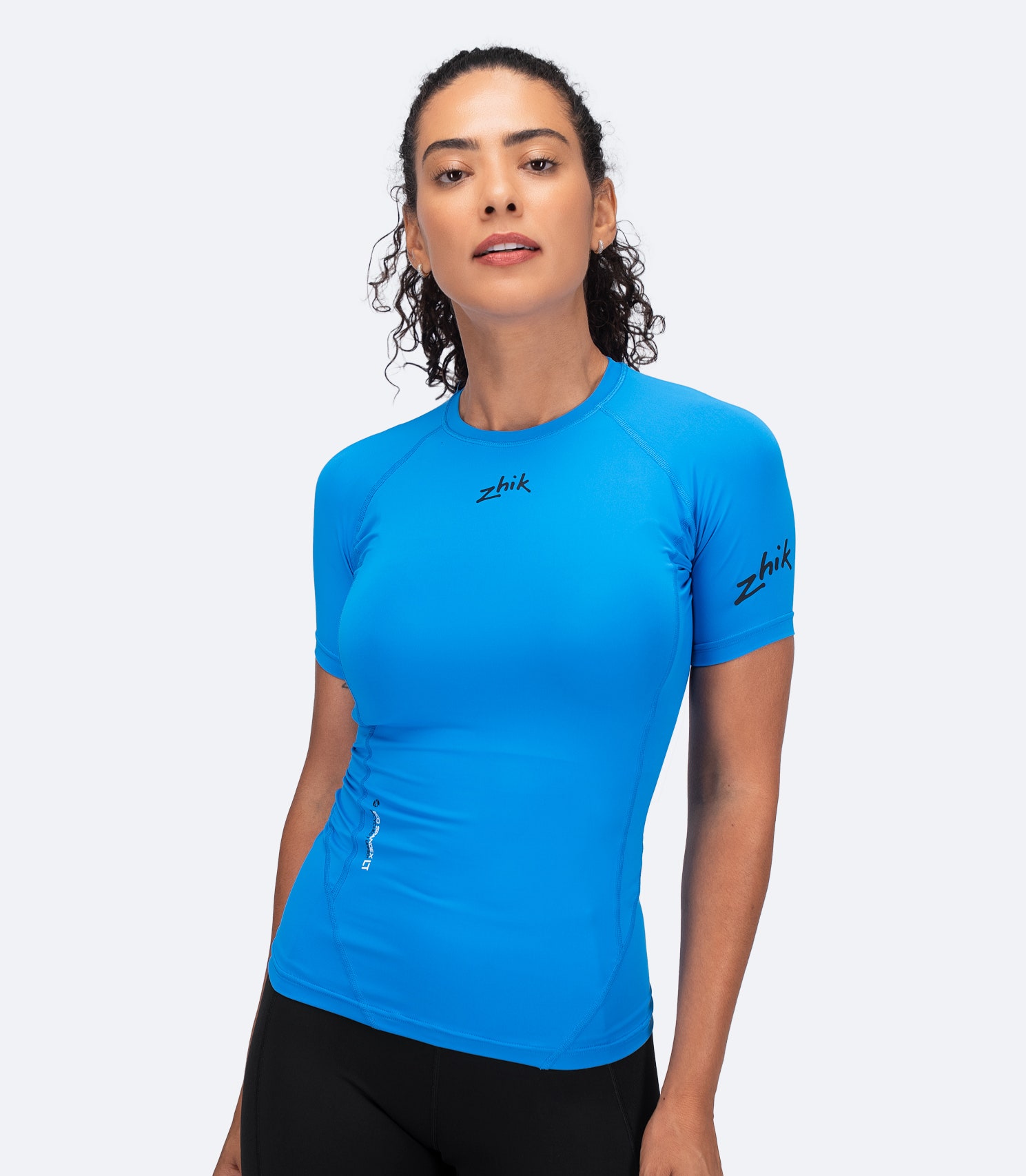 Zhik Women's Eco Spandex LT Baselayer Top in Cyan, front view showing lightweight, breathable fit with 3D body mapped design.