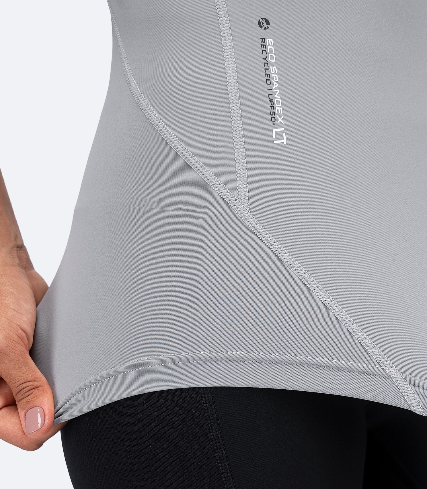 Side waist closeup of Platinum Zhik Eco Spandex LT Top showing contour fit and high-stretch recycled fabric.