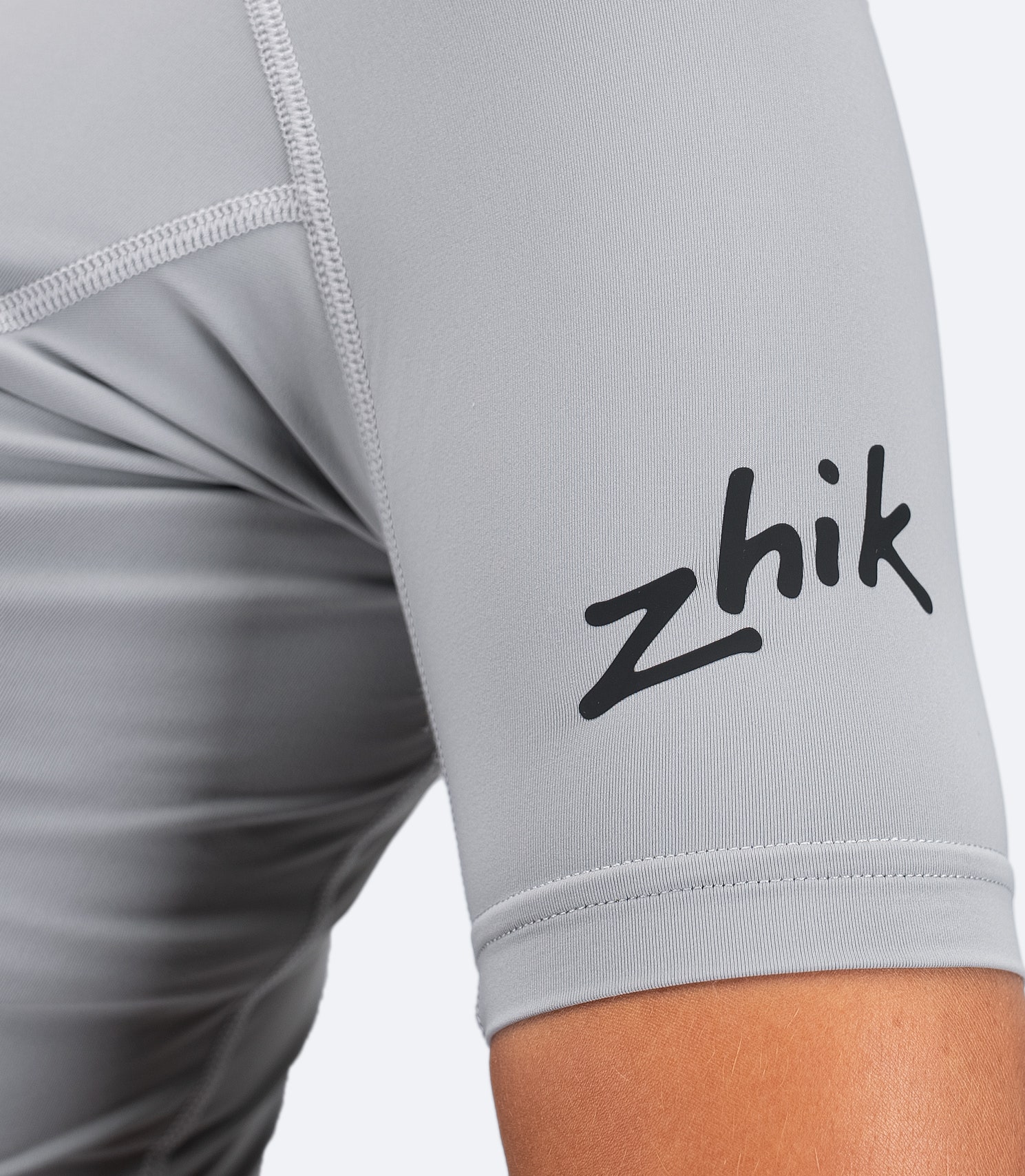 Platinum Zhik Eco Spandex LT Top arm detail with visible Zhik logo, soft stretch fabric and UV protective construction.