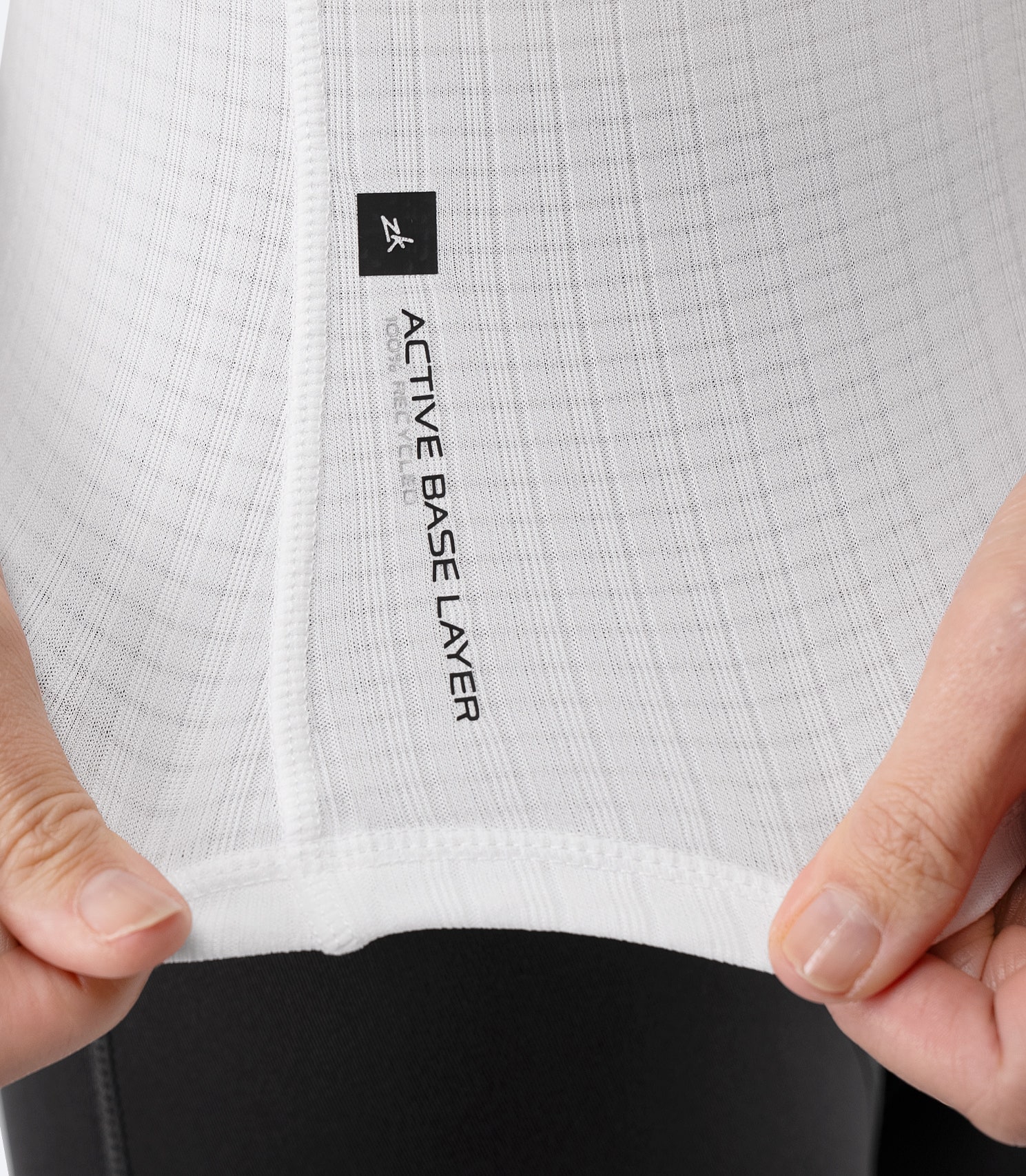 Close-up of hem label on Zhik Women’s Active Baselayer Top in white