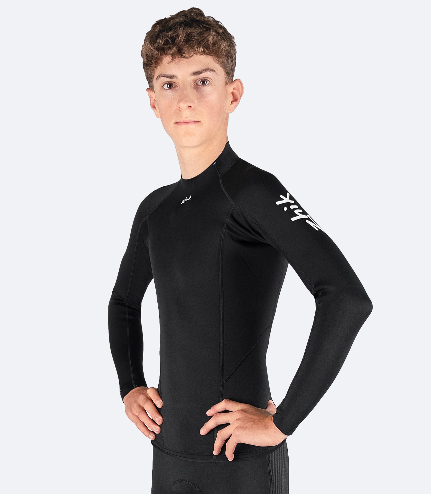 Front view of Zhik Youth Microfleece Top, featuring a mid-profile collar, shaped raw front, and flatlock seam construction for durability