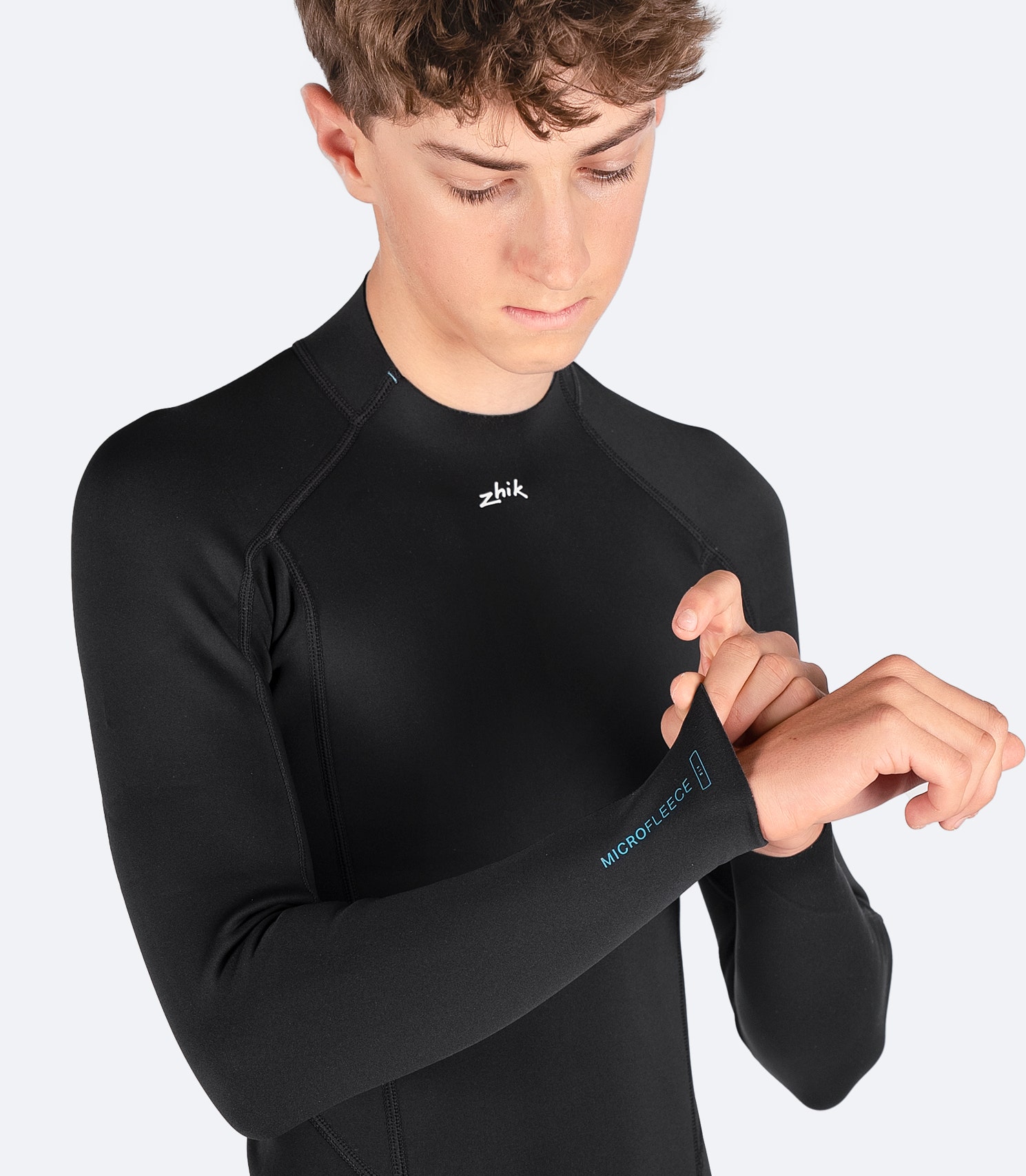 Close-up of Zhik Youth Microfleece Top’s fabric, showcasing the 4-way stretch material and quick-dry internal lining for performance