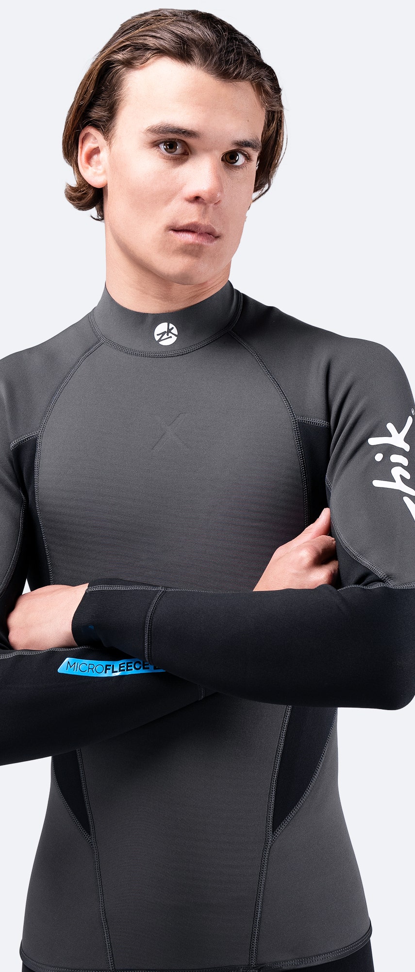 Men's Microfleece™ X Top by Zhik – black wetsuit top with arms crossed, showcasing flexibility and performance fit.