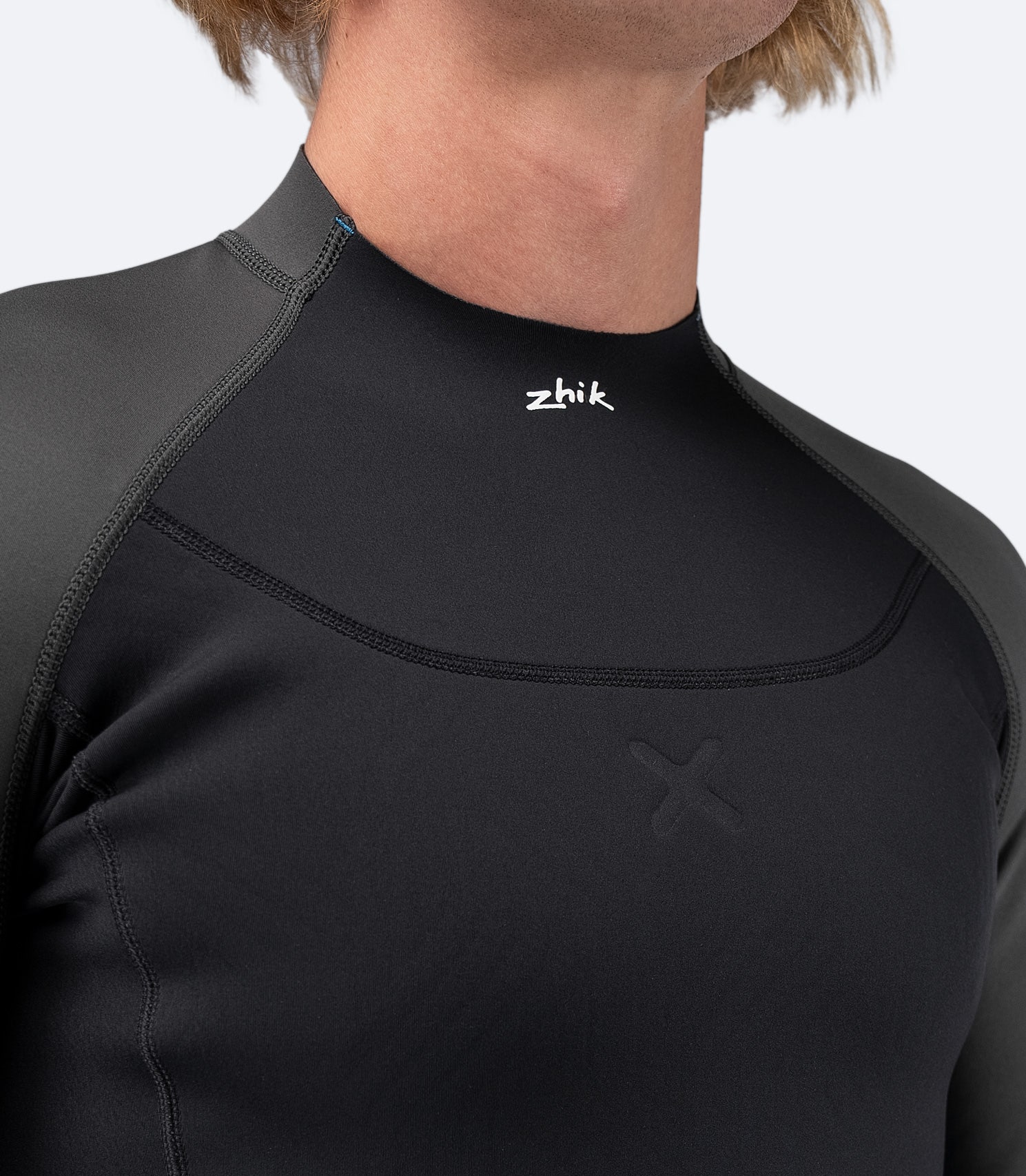 Close-up of the mid-profile collar on Zhik Men's MicrofleeceX Top, featuring a shaped raw front for comfort and enhanced fit.