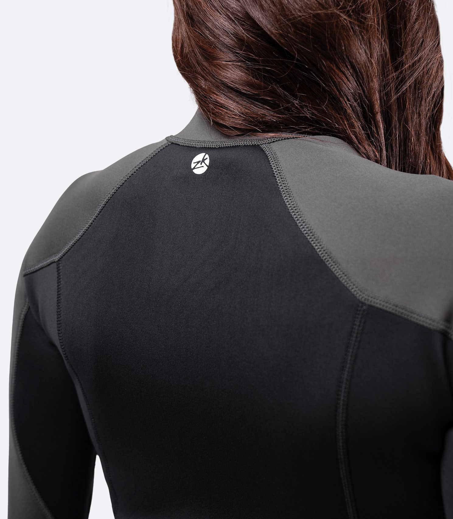 Close-up of Zhik Women's MicrofleeceX Top’s fabric, featuring eco aqua glue, naturally sourced Yulex® rubber, and recycled PET lining.