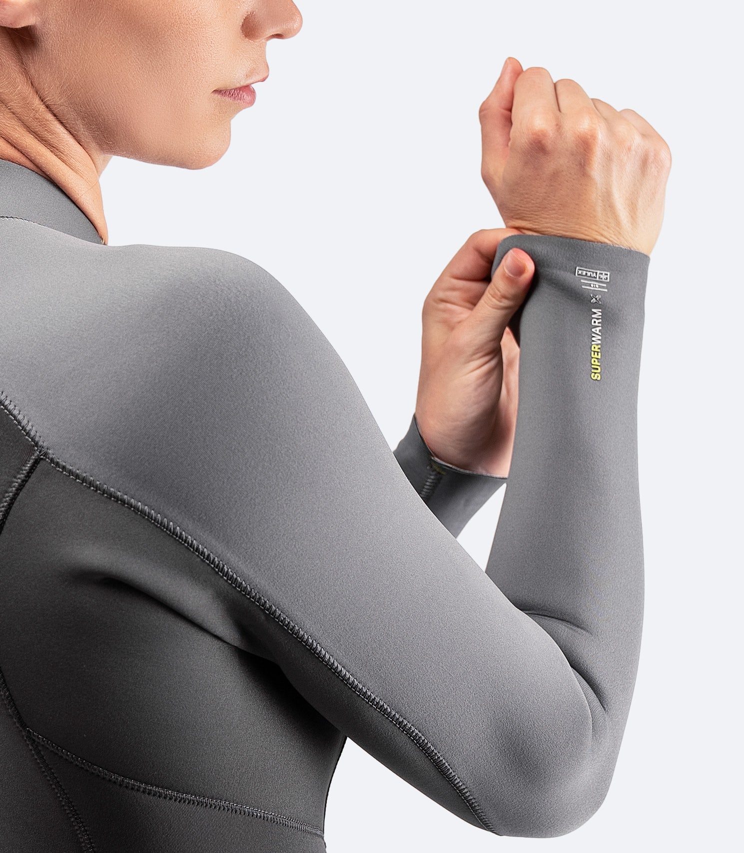 Detail shot of the Zhik Women's SuperwarmX Top in grey, showcasing the flexible stretch fabric and sleek finish