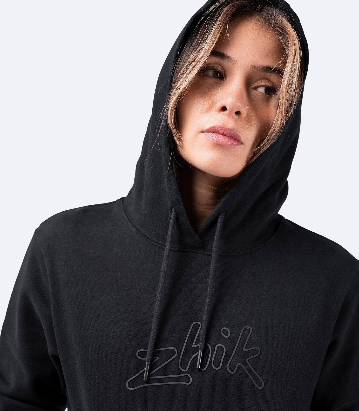 Close-up of Zhik Women's Cotton Hoodie in black – hood on, soft cotton fabric, and Zhik logo detail.