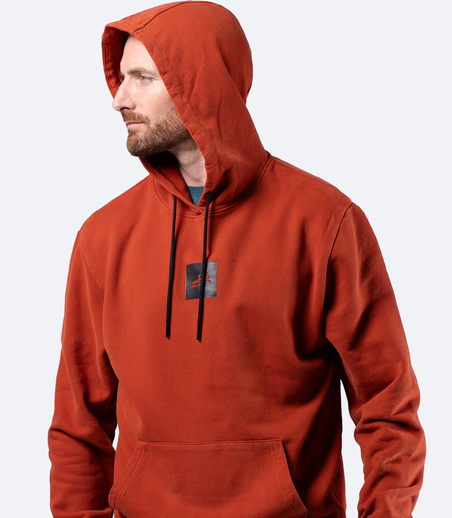 Zhik Men's Carbon Hoodie in Red Earth, front view with hood up, premium cotton and relaxed regular fit