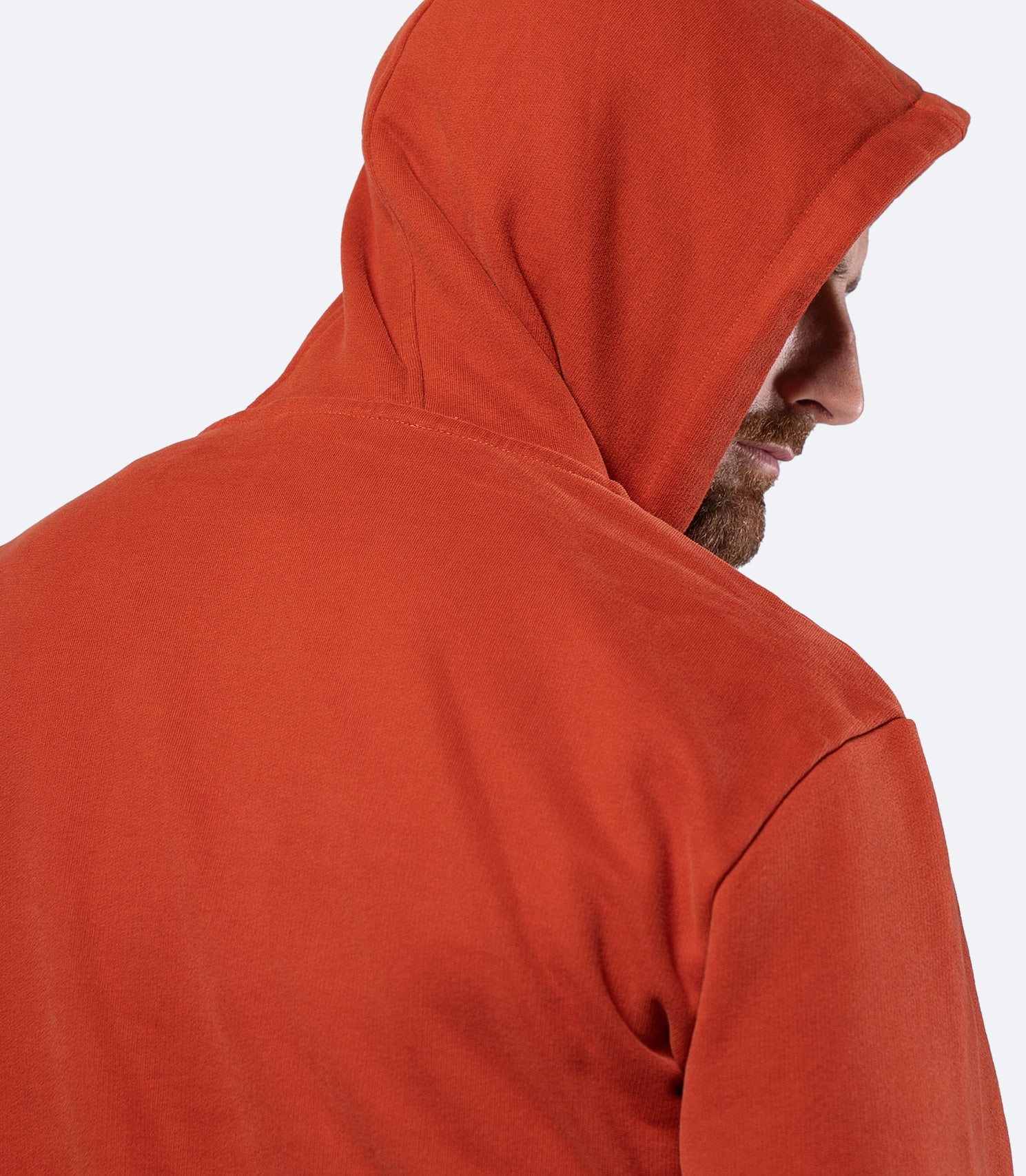 Side view of Red Earth Zhik Men's Carbon Hoodie with hood up, breathable midweight cotton for layering