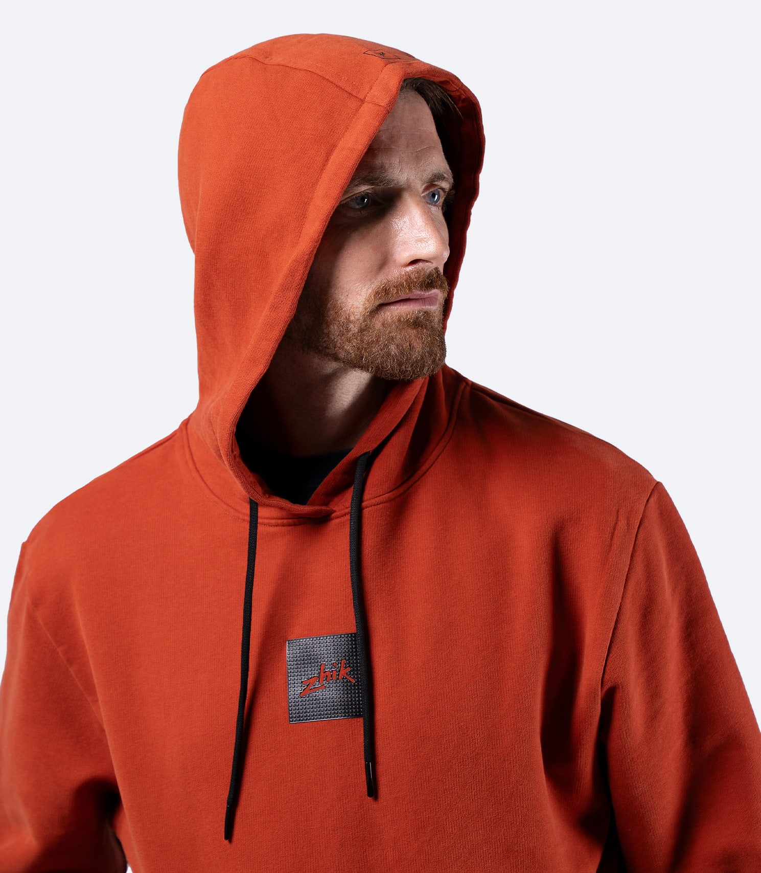 Zhik Men's Carbon Hoodie in Red Earth, front view with hood up, premium cotton and relaxed regular fit