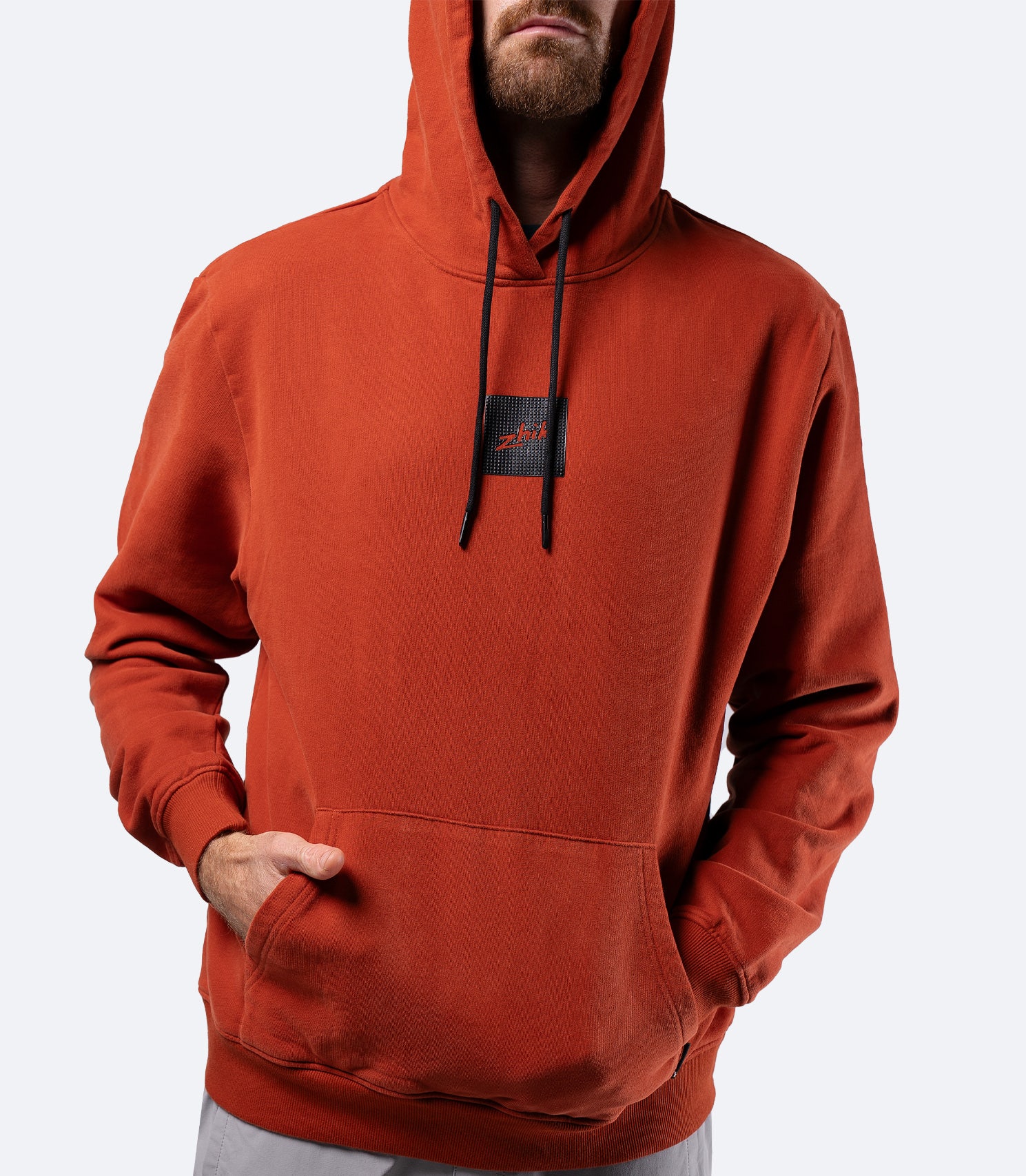 Zhik Men's Carbon Hoodie in Red Earth, front view with hood up, premium cotton and relaxed regular fit