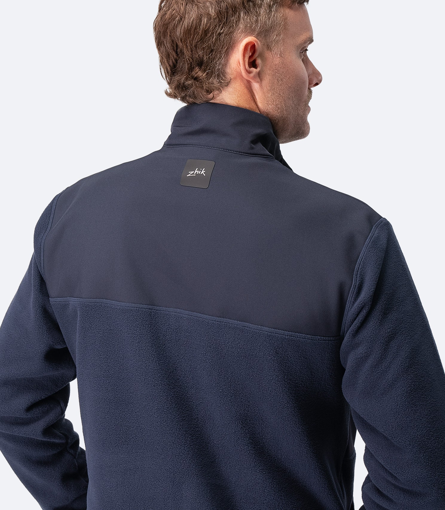 Rear view of Zhik Men's Hybrid Fleece Jacket in midnight blue, showing lightweight fleece construction and relaxed fit
