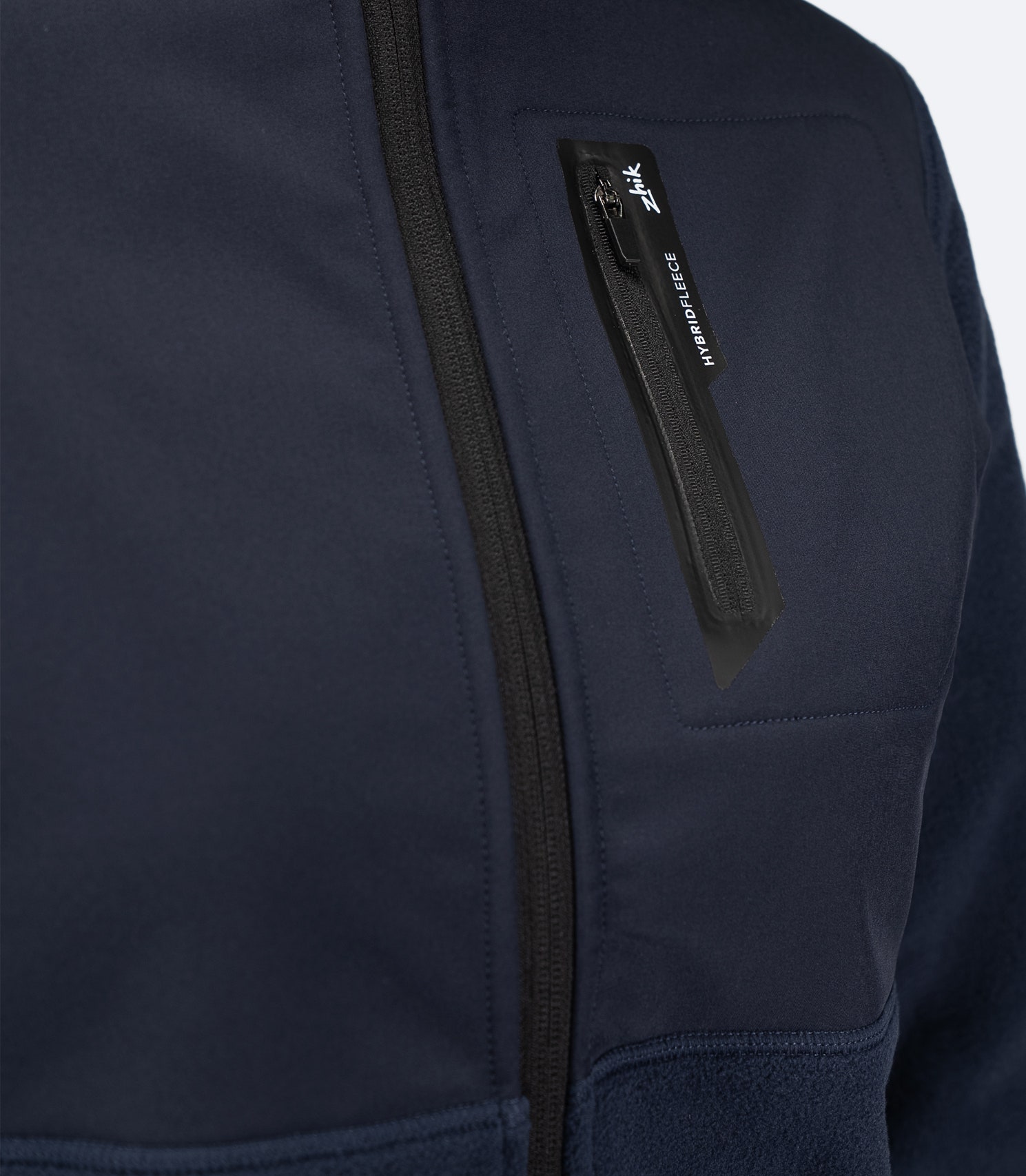 Zhik Women's Hybrid Fleece Jacket in midnight blue with an easily accessible external chest pocket for secure storage on and off the water.