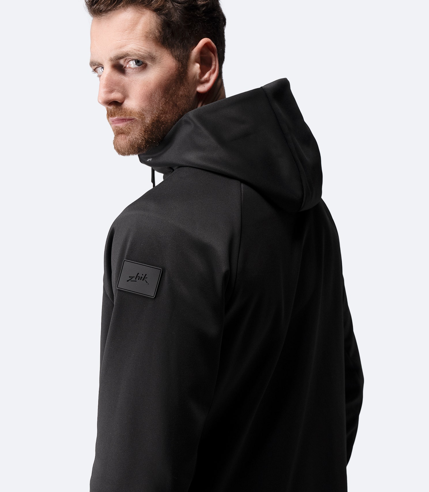 Side profile of Zhik Men’s Thermo TechFleece Hooded Jacket in black