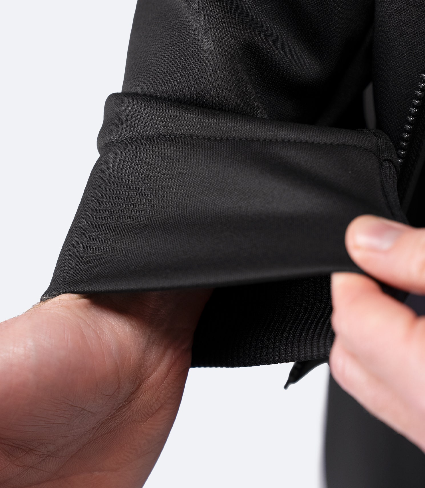 Close-up of sleeve cuff detail on Zhik Men’s Thermo TechFleece Hooded Jacket in black