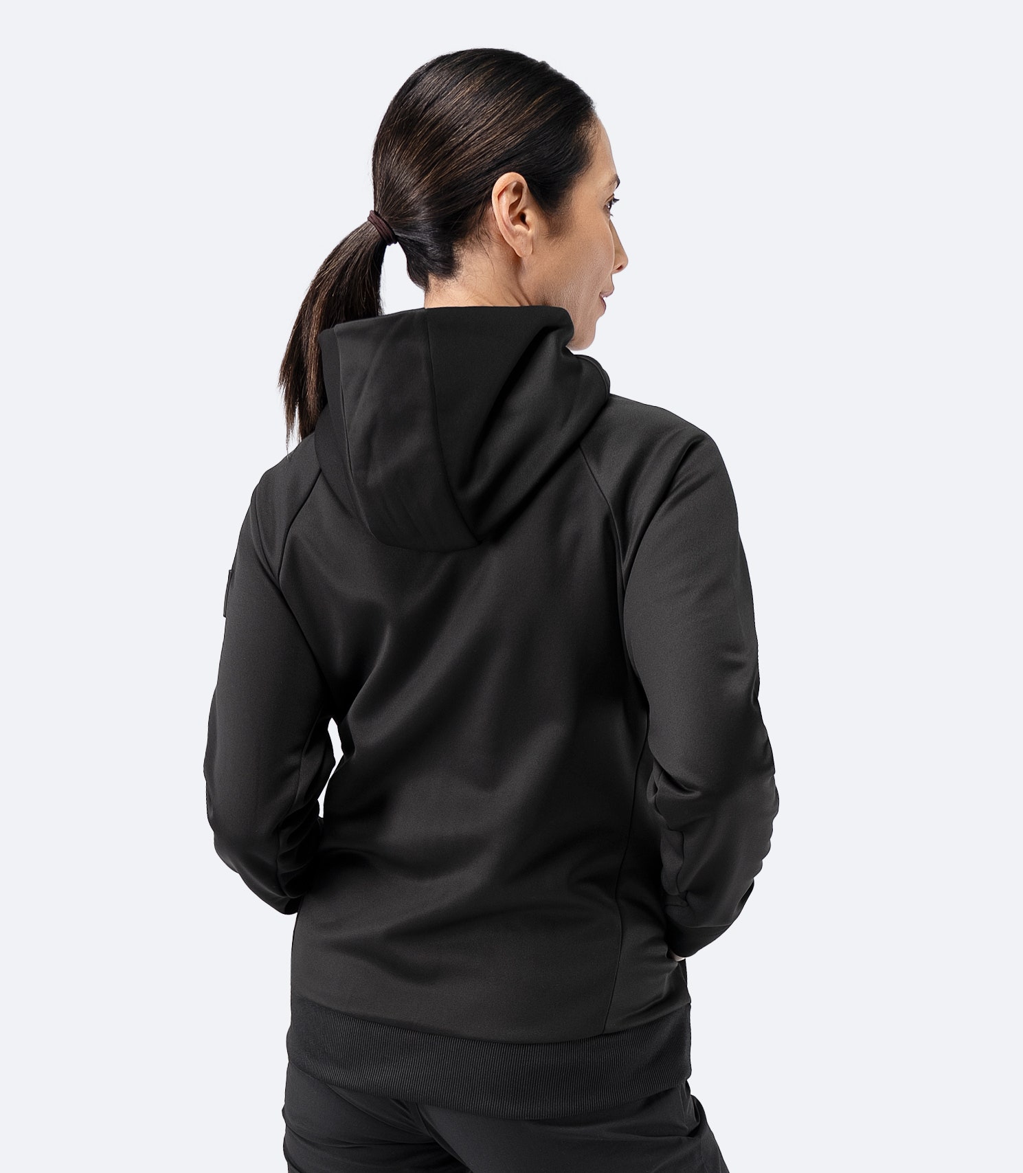 Back view of Zhik Women’s Thermo TechFleece Hooded Jacket in black with hood raised