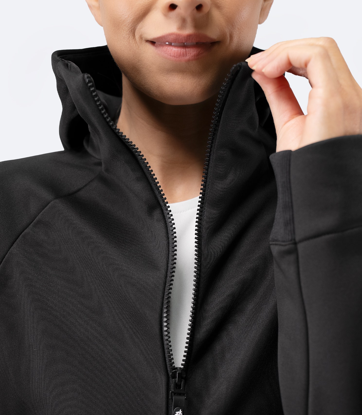 Close-up of zipper and collar detail on Zhik Women’s Thermo TechFleece Hooded Jacket