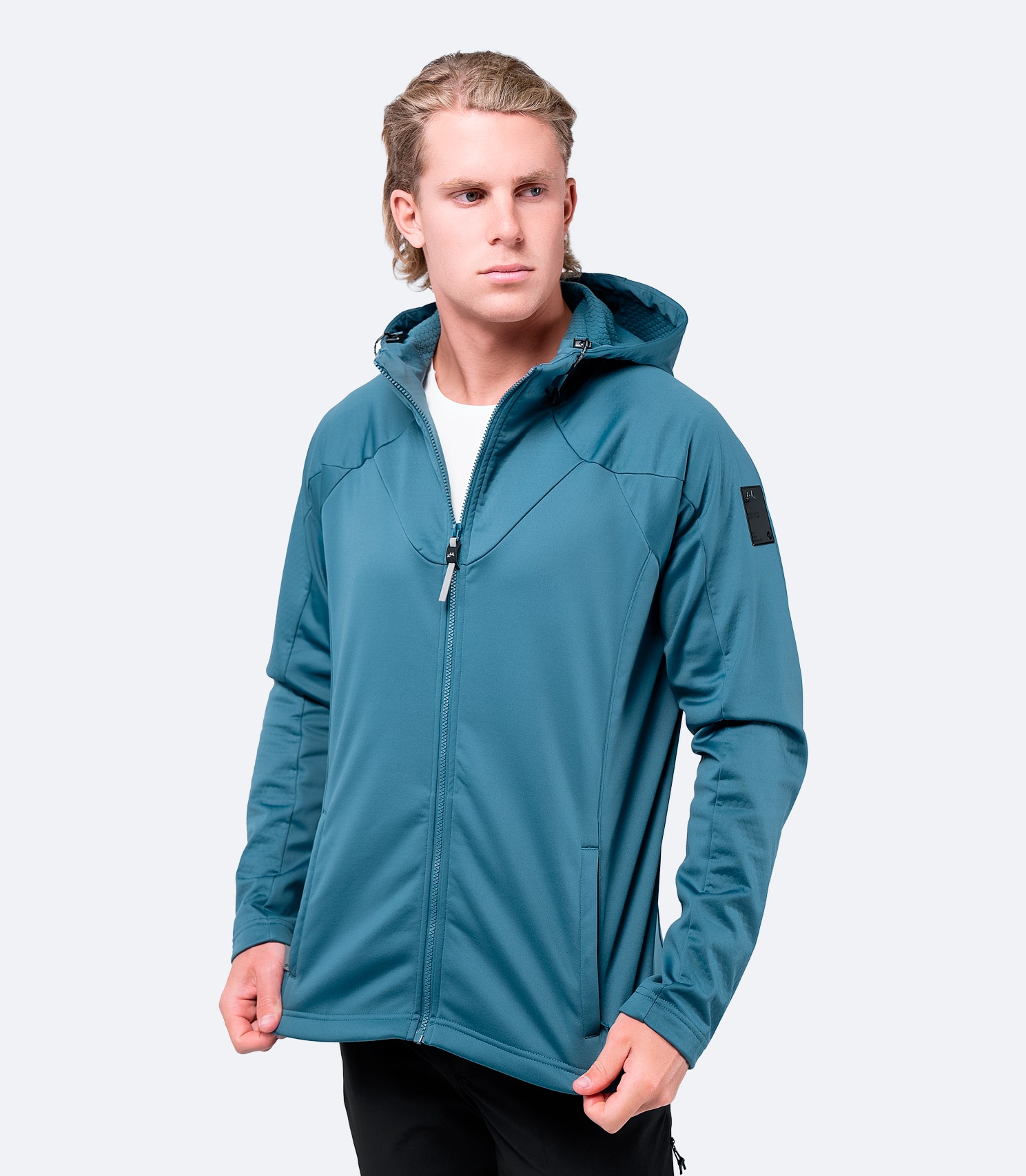 Men’s provincial blue Tech Hoodie by Zhik, worn casually, highlighting active fit and modern styling.