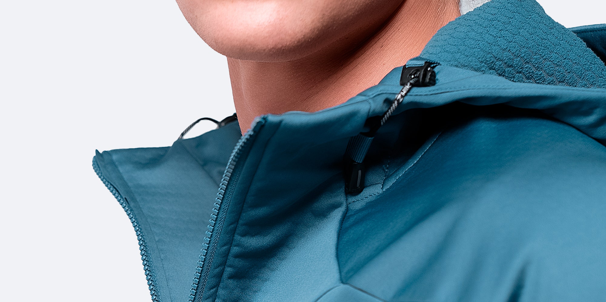 Close-up of provincial blue Tech Hoodie’s shoulder, and collar, showcasing waterproof construction.
