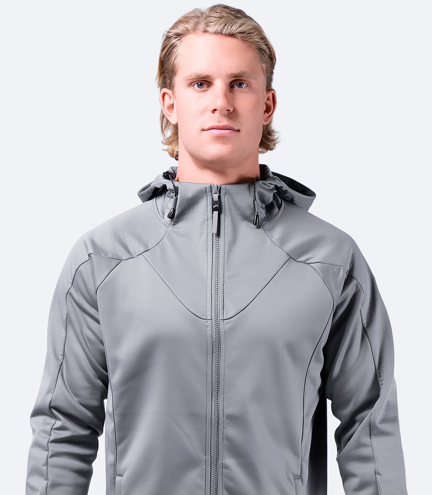 Men’s platinum Tech Hoodie by Zhik, front view worn casually, highlighting active fit and performance styling.