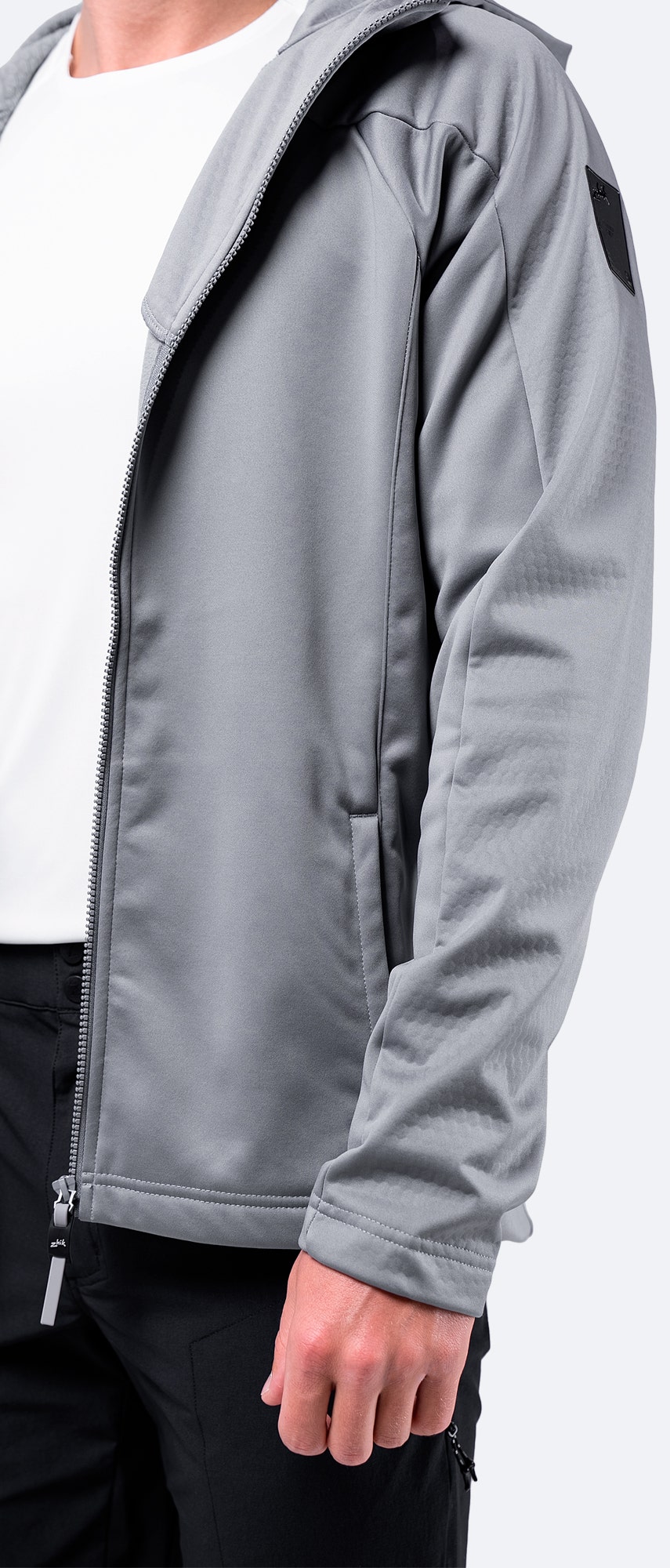 Close-up of the right sleeve fabric on the platinum Zhik Men's Tech Hoodie, highlighting high-stretch, waterproof material.