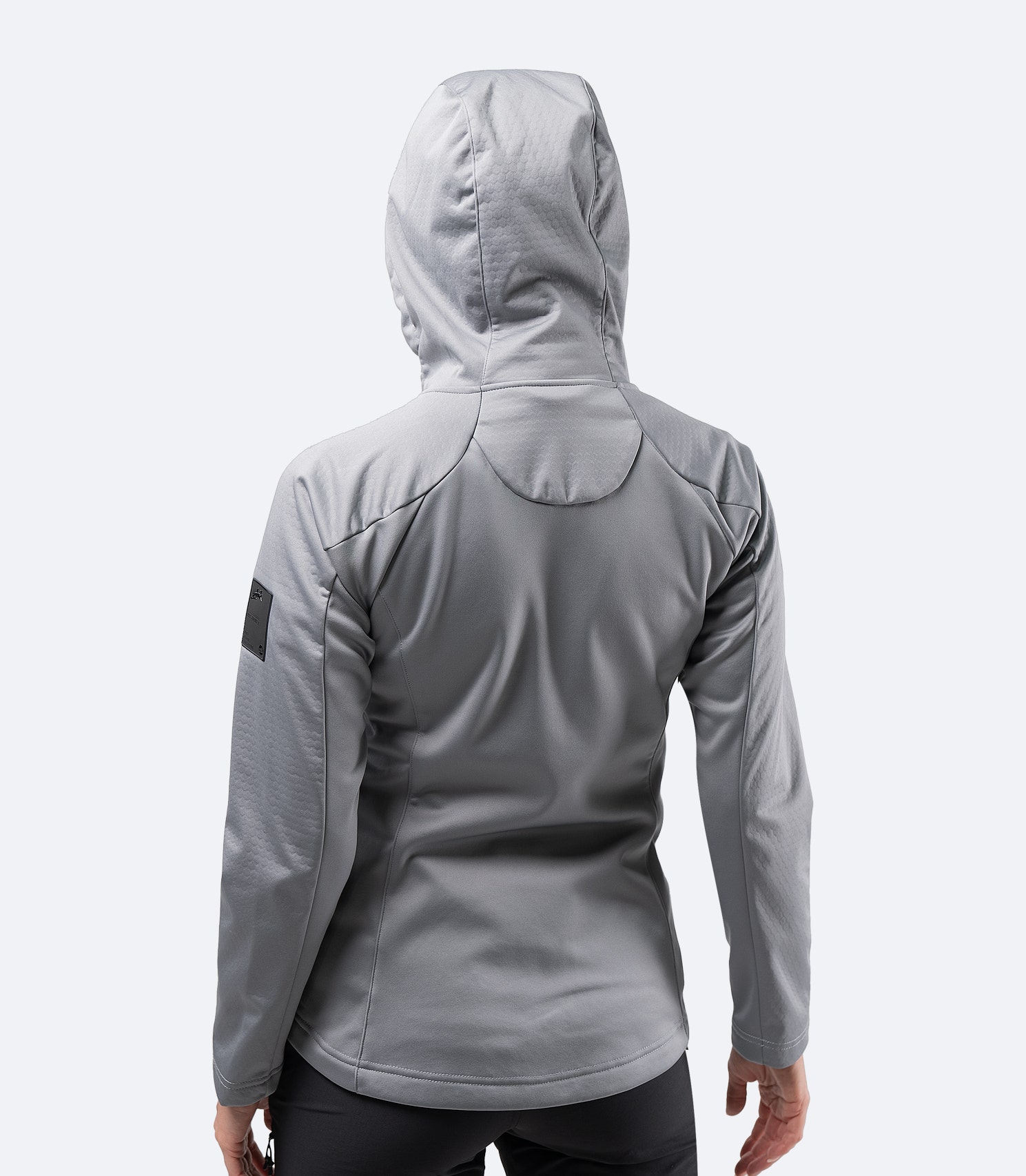 Rear view of the platinum Zhik Women's Tech Hoodie, featuring an adjustable hood and ergonomic fit.