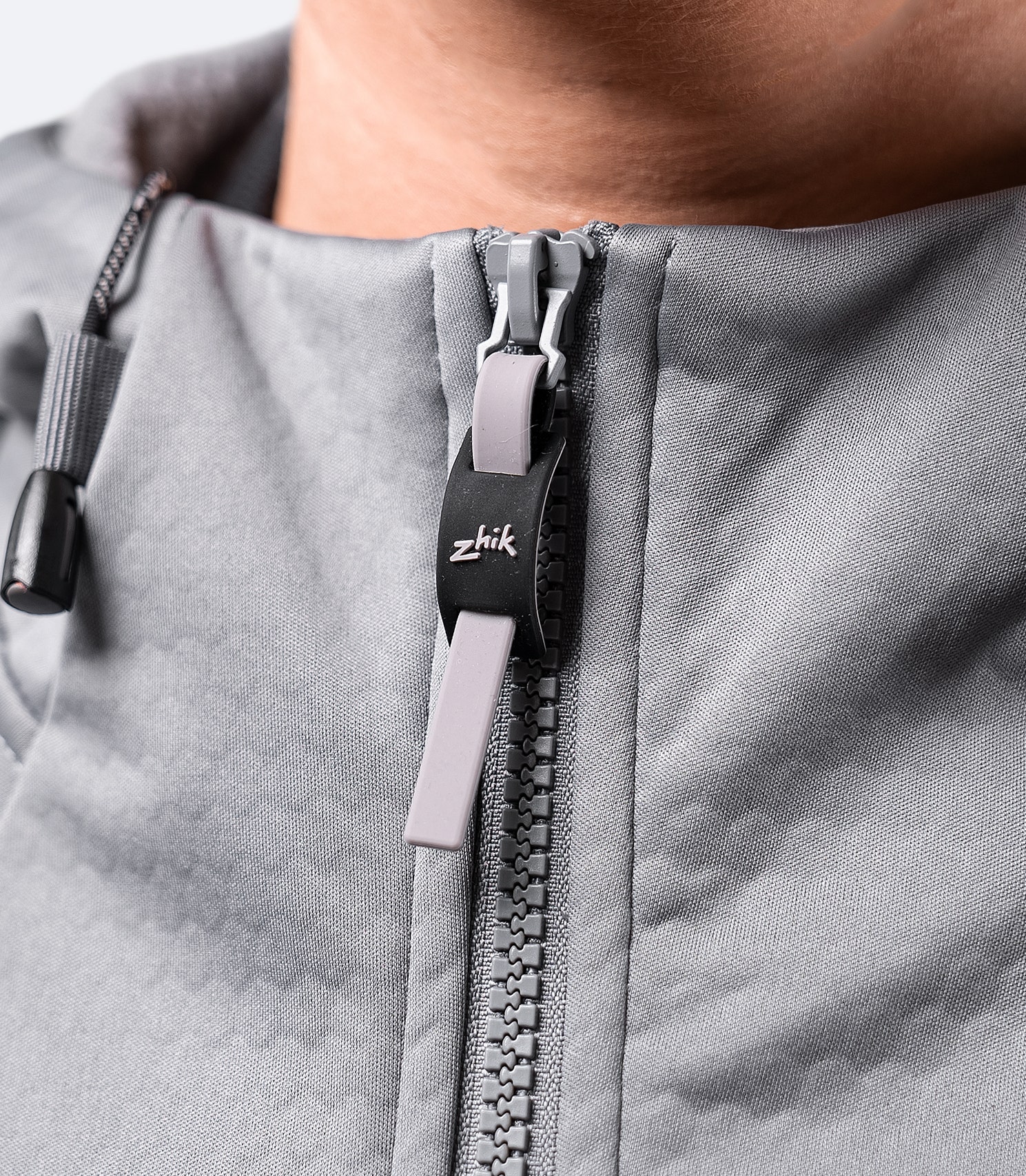 Close-up of the zipper on the platinum Zhik Women's Tech Hoodie, highlighting secure fastening and durable waterproof design.