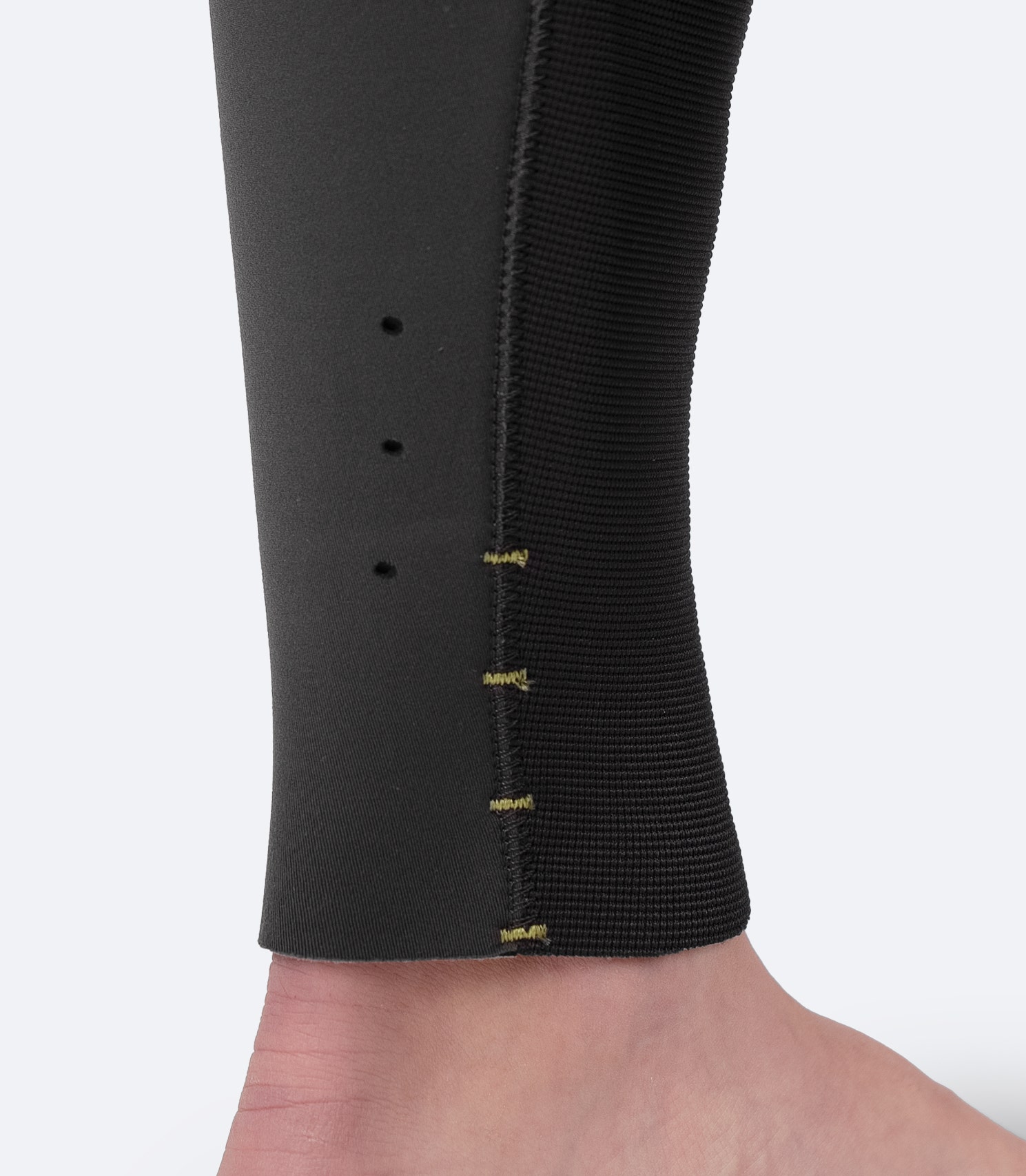 Close-up of Zhik Women's Superwarm® Hiker ankle, showing drainage holes and adjustable leg length with ready-to-cut bar tacks