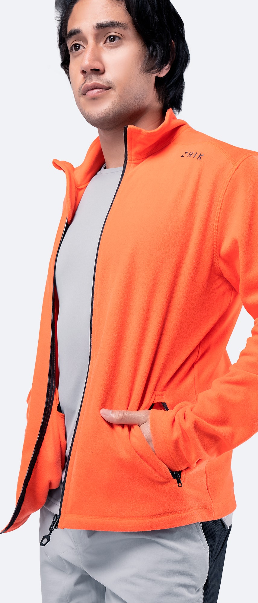 Men’s Flame Red Full Zip Fleece Jacket open with hands in pockets, revealing lightweight insulation and inner lining.