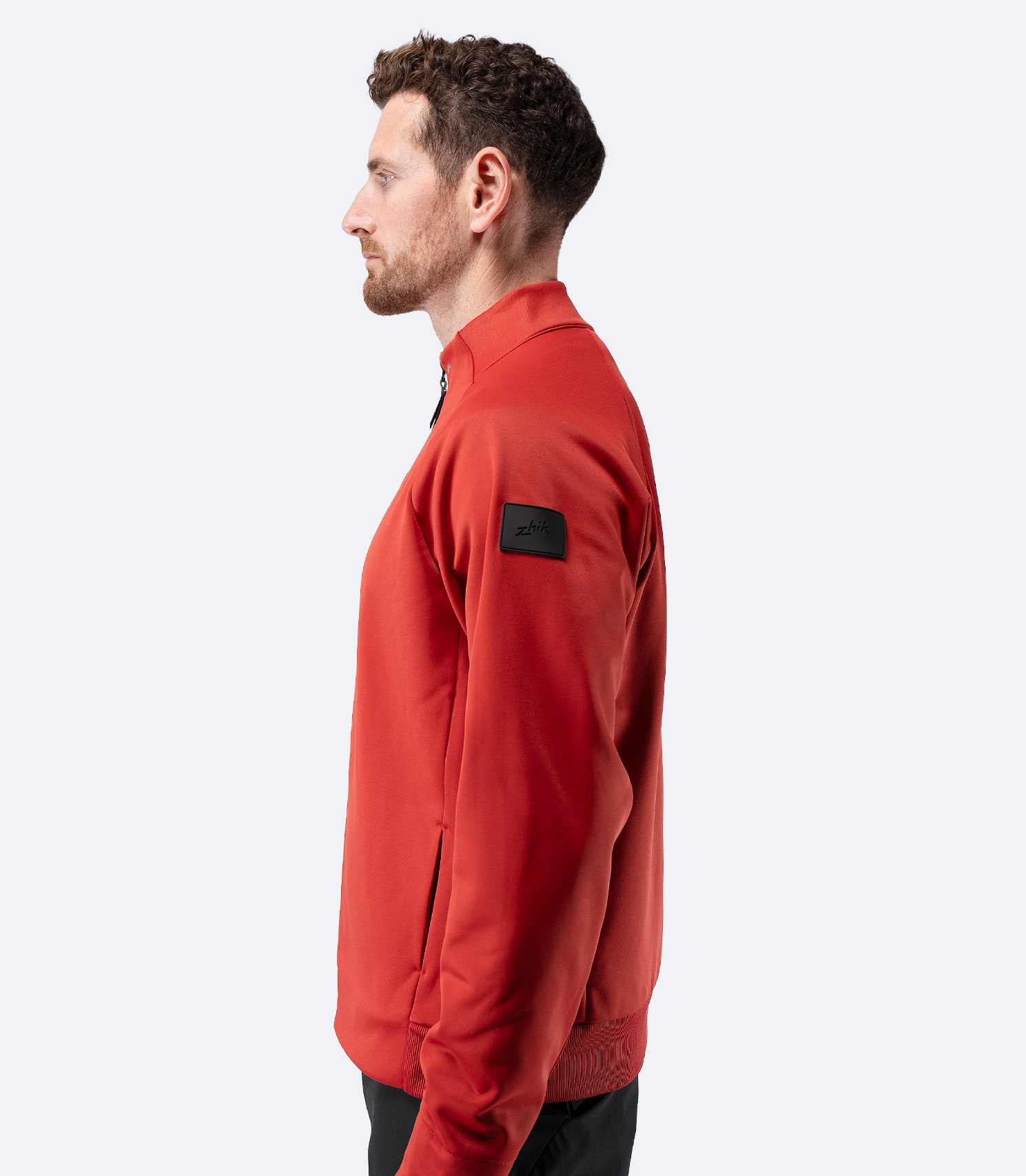 Side profile of Zhik Men’s Thermo TechFleece Sports Jacket in garnet red