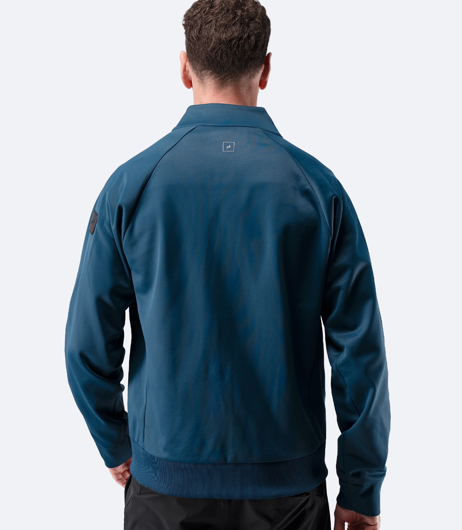 Back view of Zhik Men’s Thermo TechFleece Sports Jacket in deep teal with stand collar