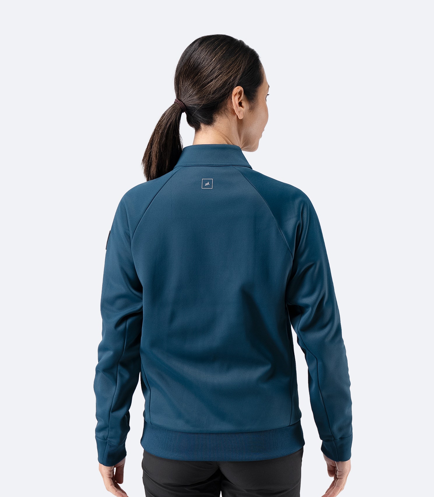 Back view of Zhik Women’s Thermo TechFleece Sports Jacket in deep teal with stand collar