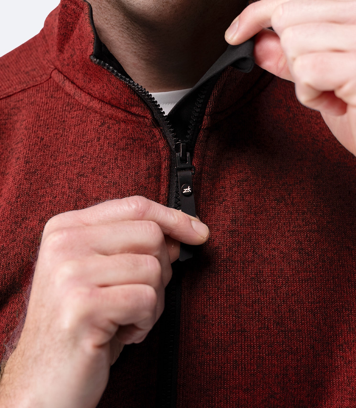 Close-up of zipper and collar detail on Zhik Men’s Knit Fleece Jacket in garnet marle