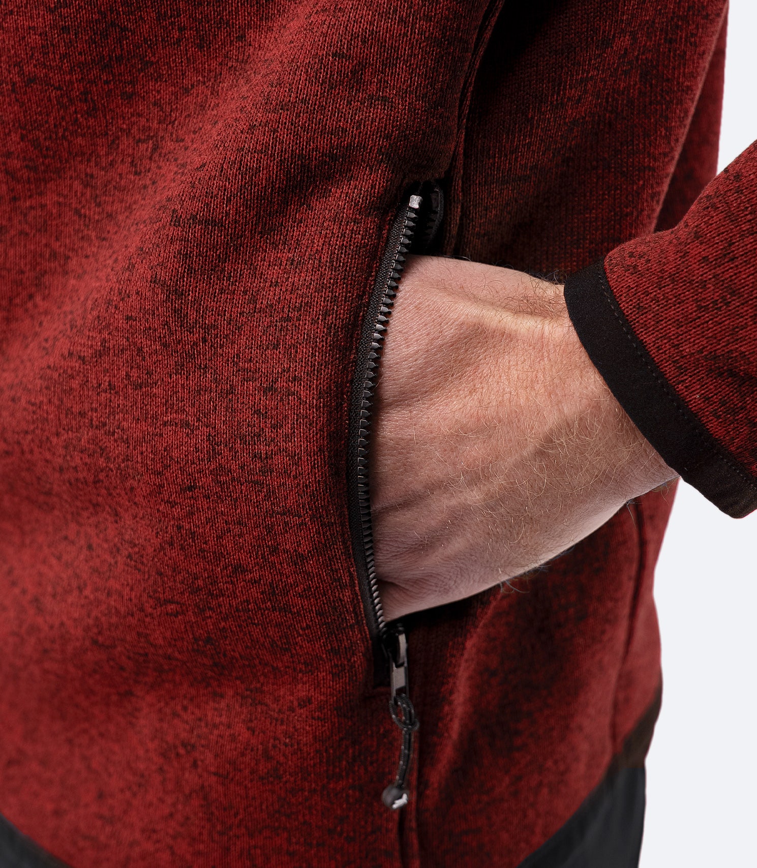 Close-up of zippered side pocket on Zhik Men’s Knit Fleece Jacket in garnet marle
